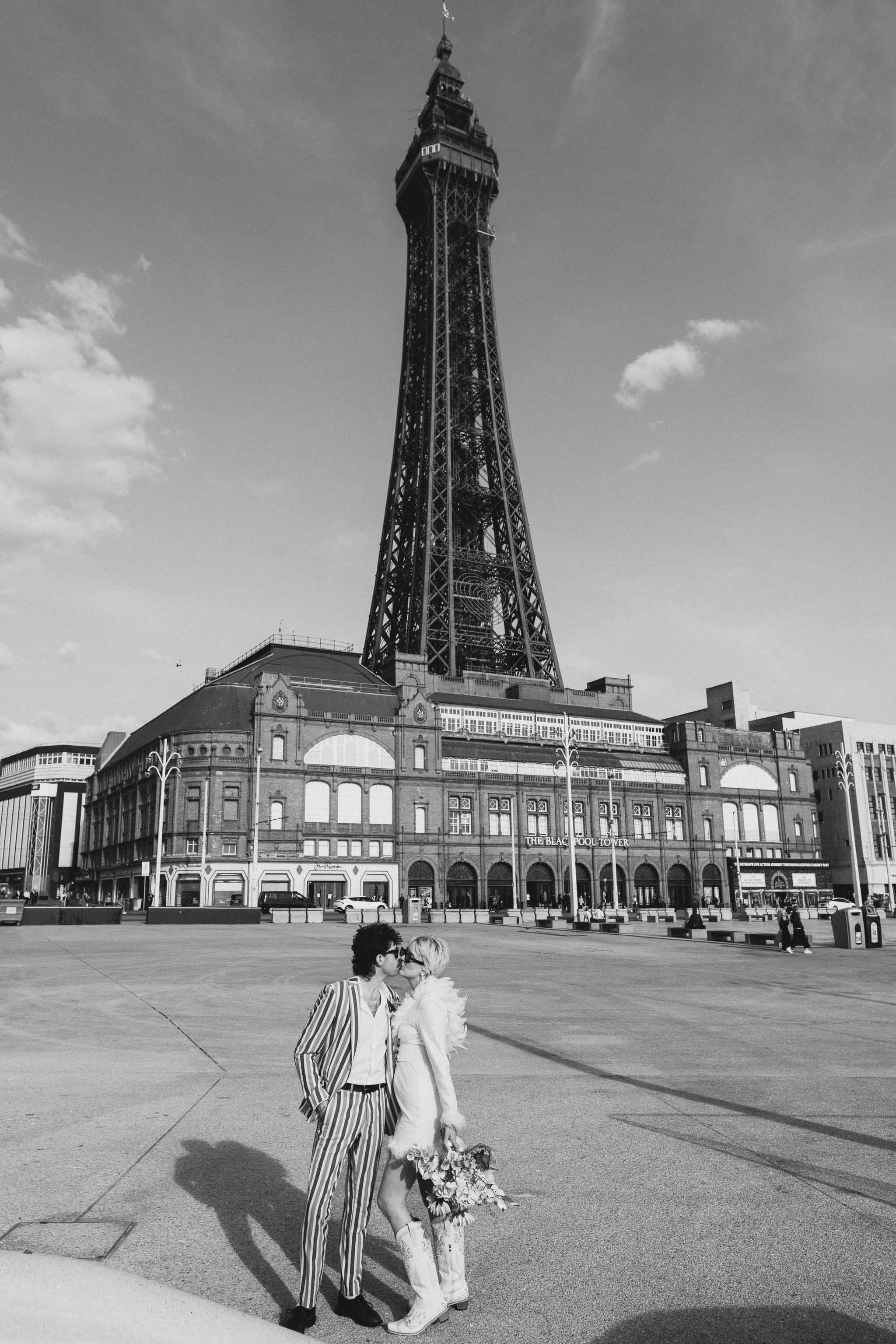 Couple stood in front of Blackpool tower kissing micro wedding elopement