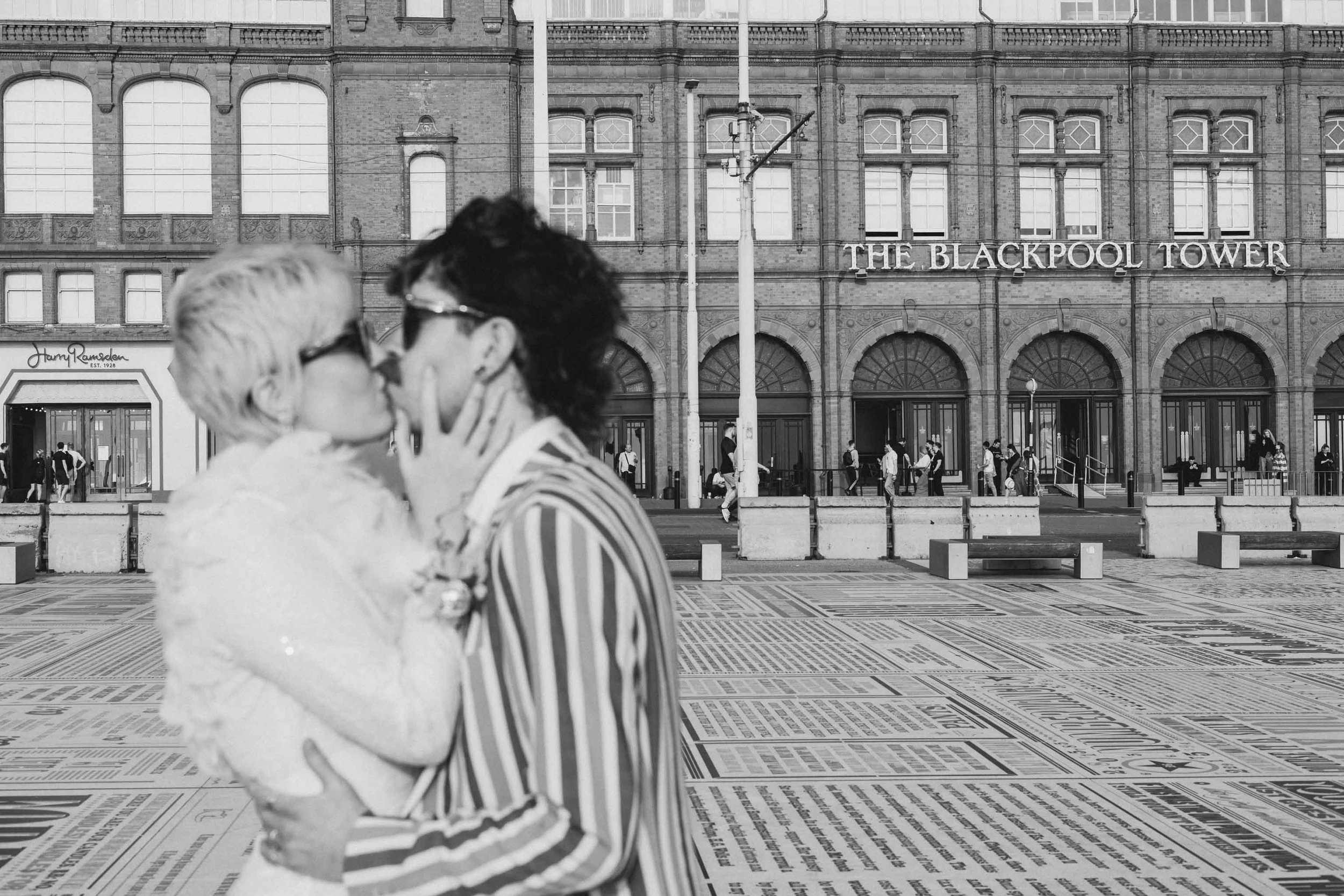Newlywed couple kissing in front of the Tower Ballroom in Blackpool