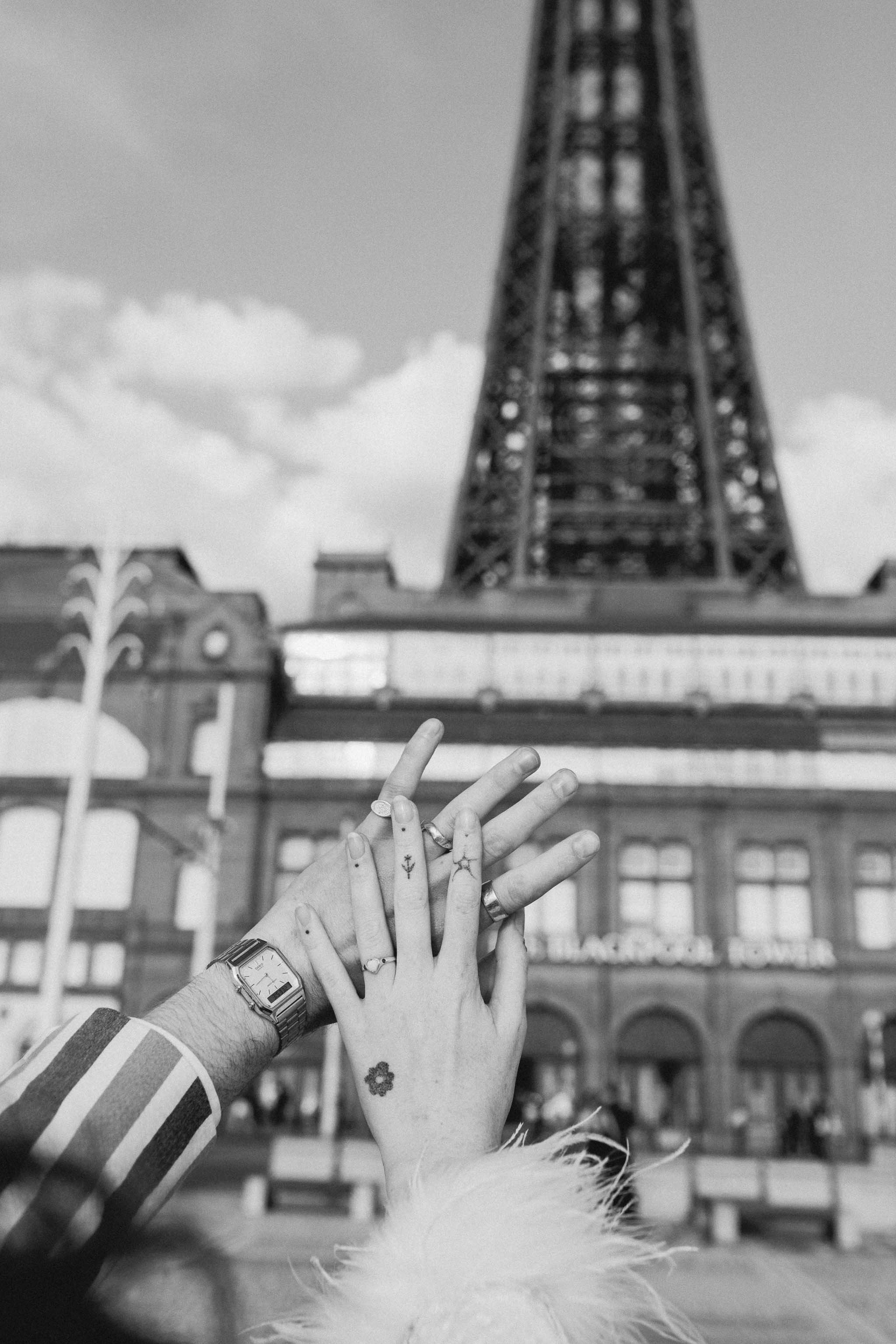 Close up photo of wedding rings in front of Blackpool Tower