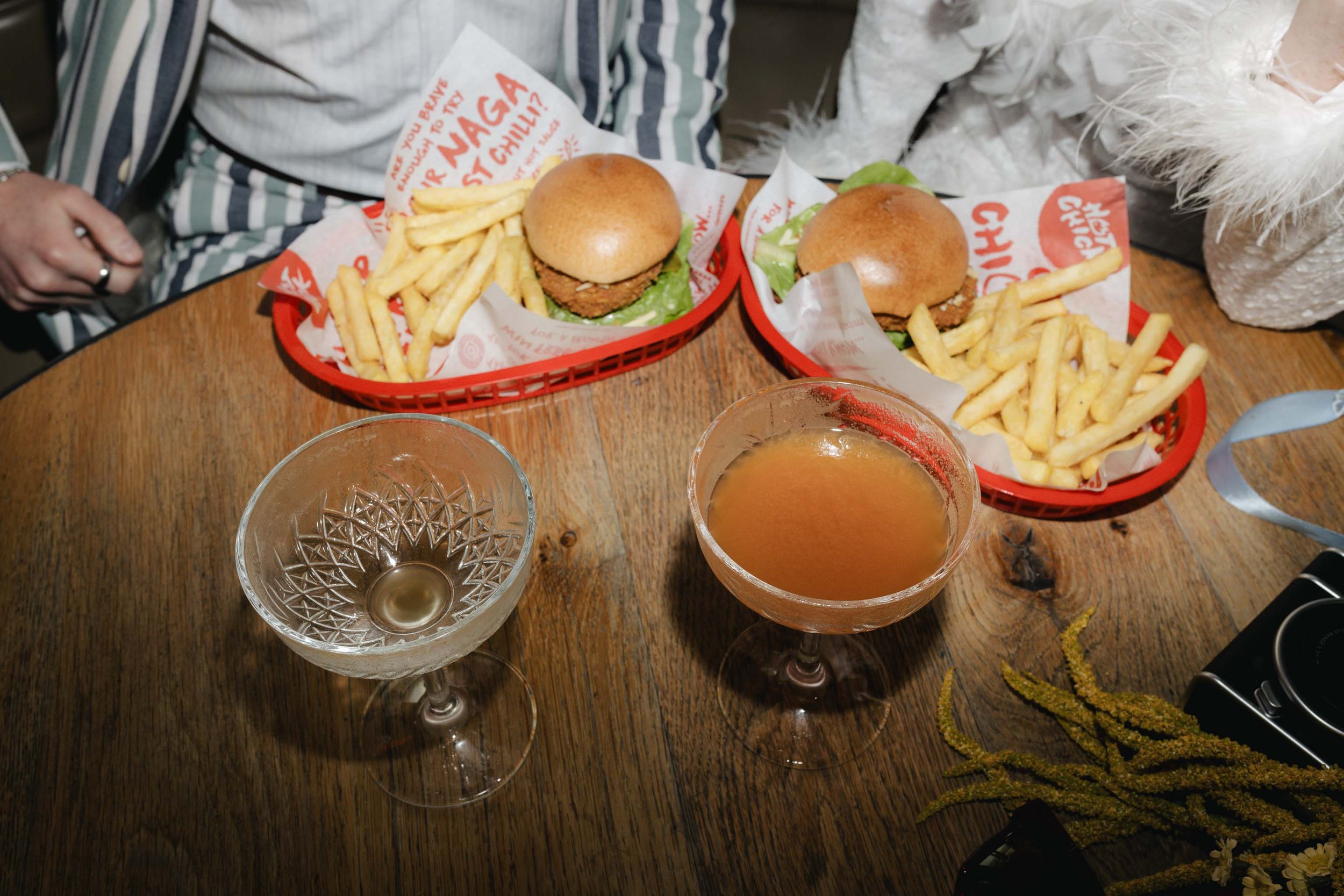 Newlyweds enjoying casual burgers and fries on their wedding day