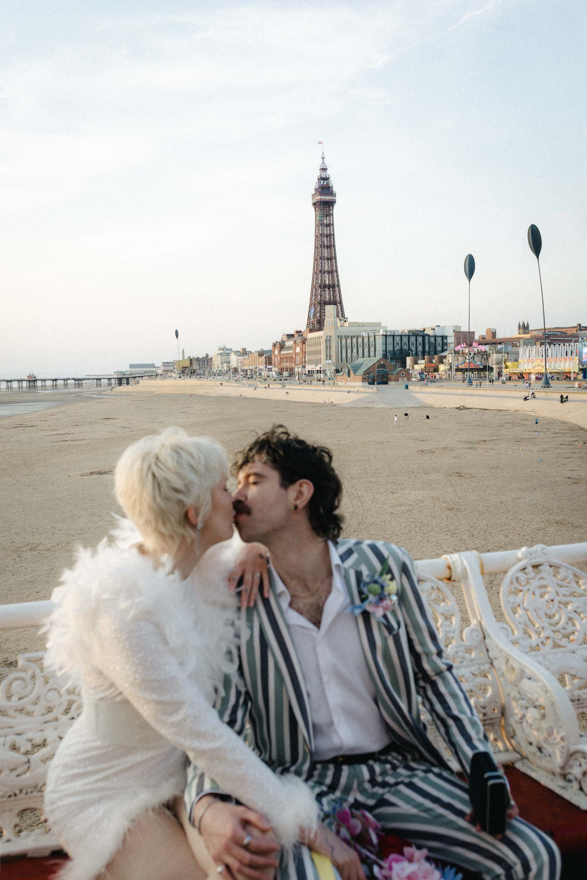 Newlywed portrait of a couple kissing in front of the Blackpool Tower