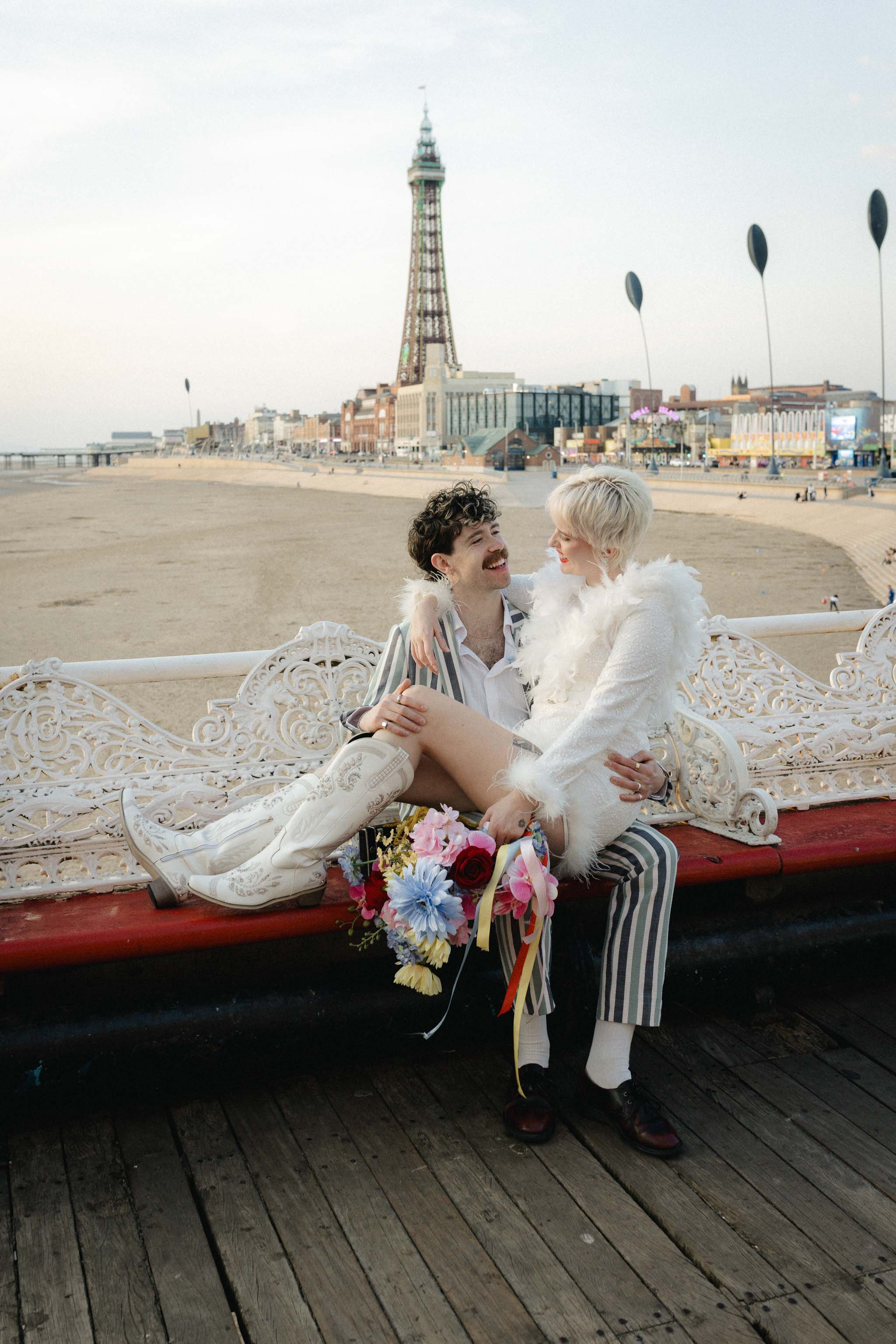 Newlywed portrait of a couple laughing in front of the Blackpool Tower