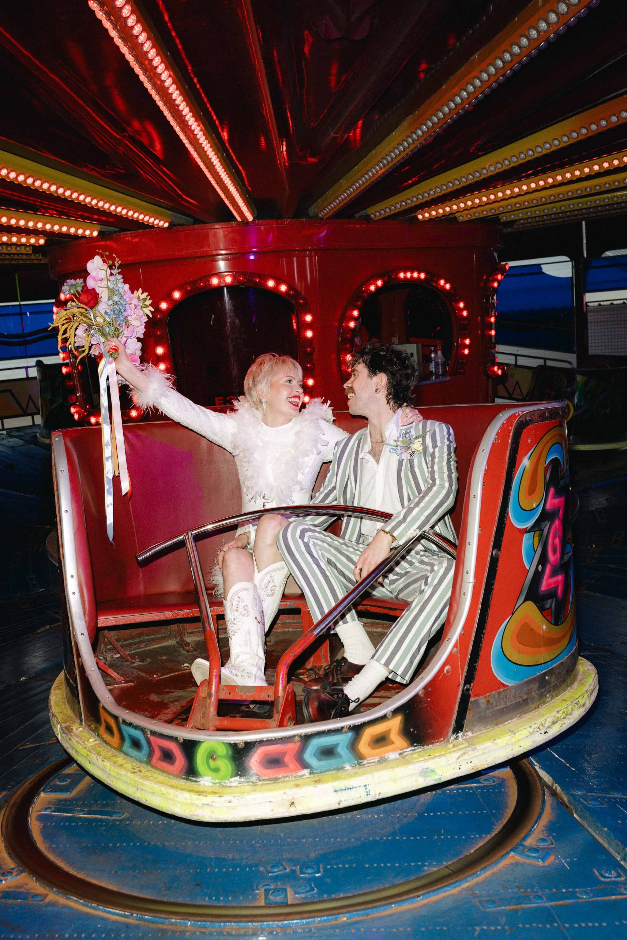 Bride and groom having fun on a vintage fairground ride during their wedding in Blackpool