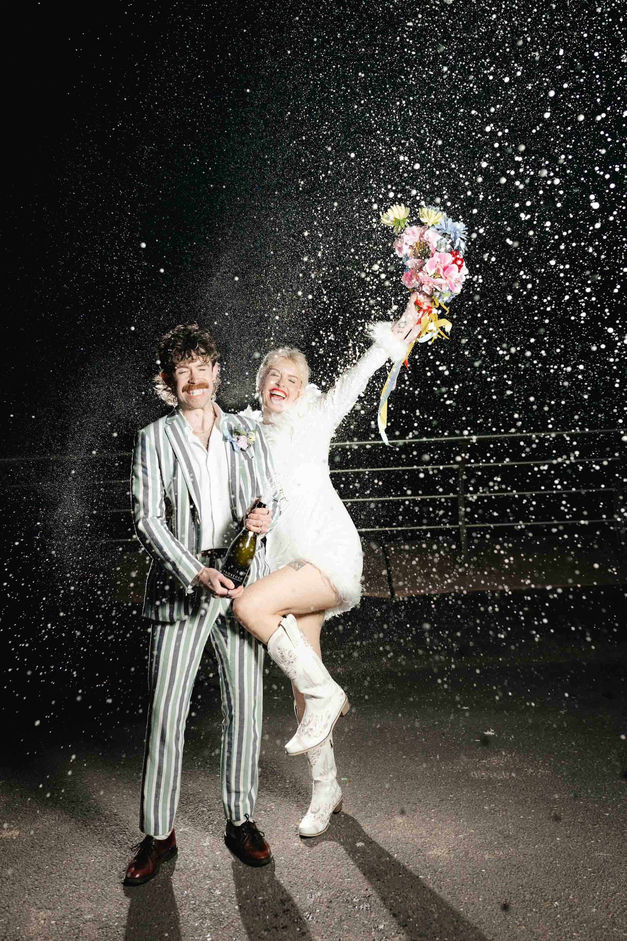 Bride and groom doing a champagne spray on Blackpool seafront