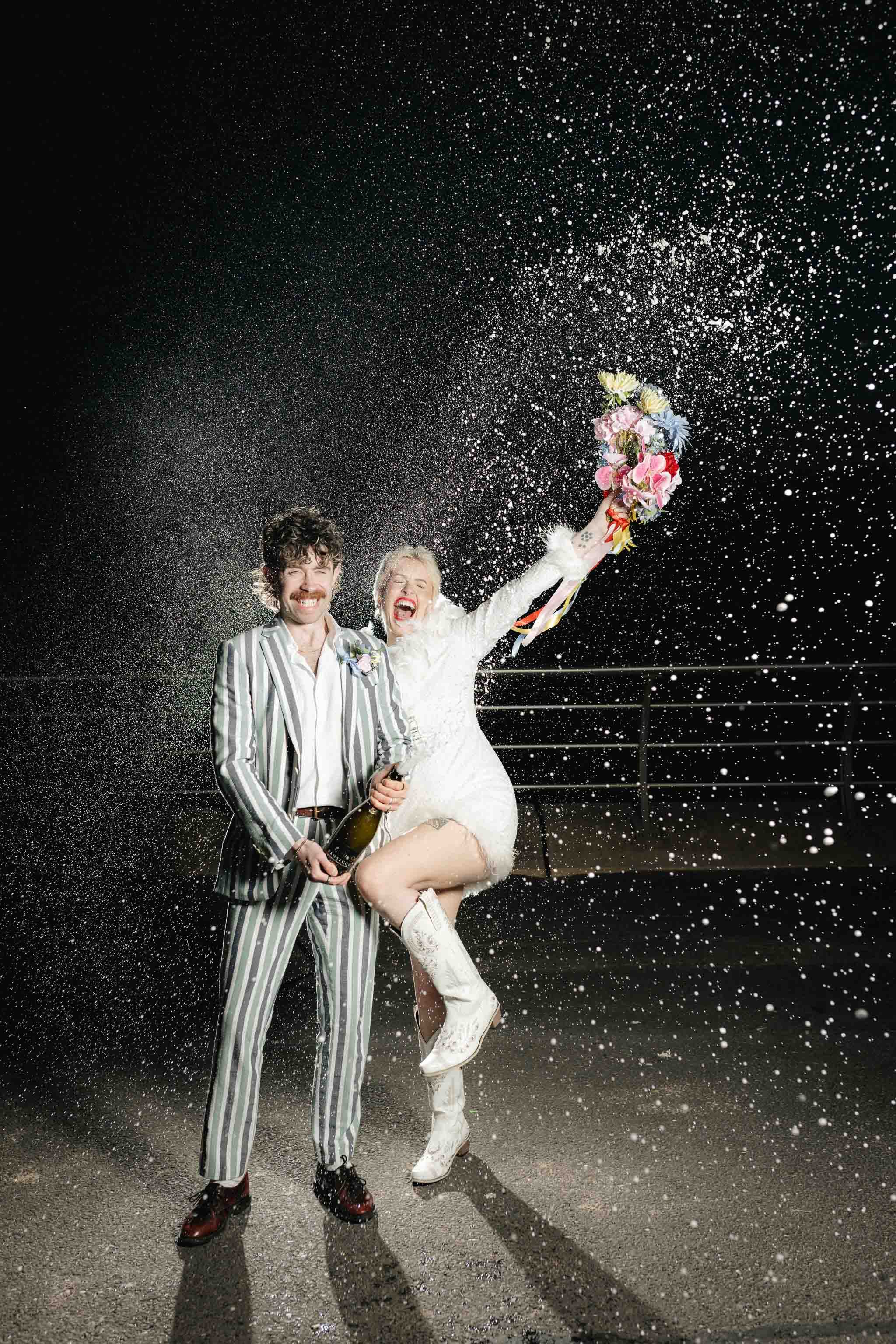 Couple doing a champagne spray after their elopement