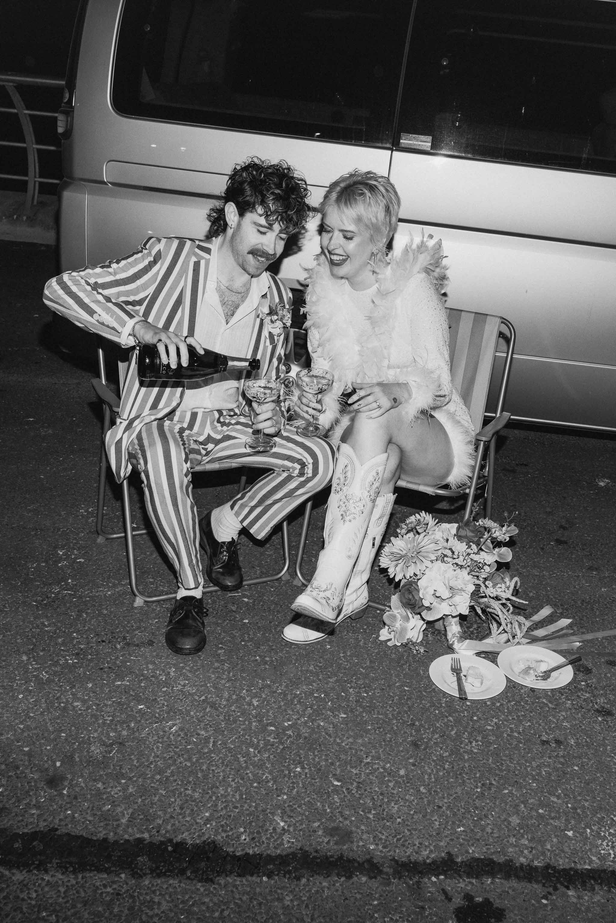 Bride and groom drinking champagne infant of their camper van at a Blackpool elopement