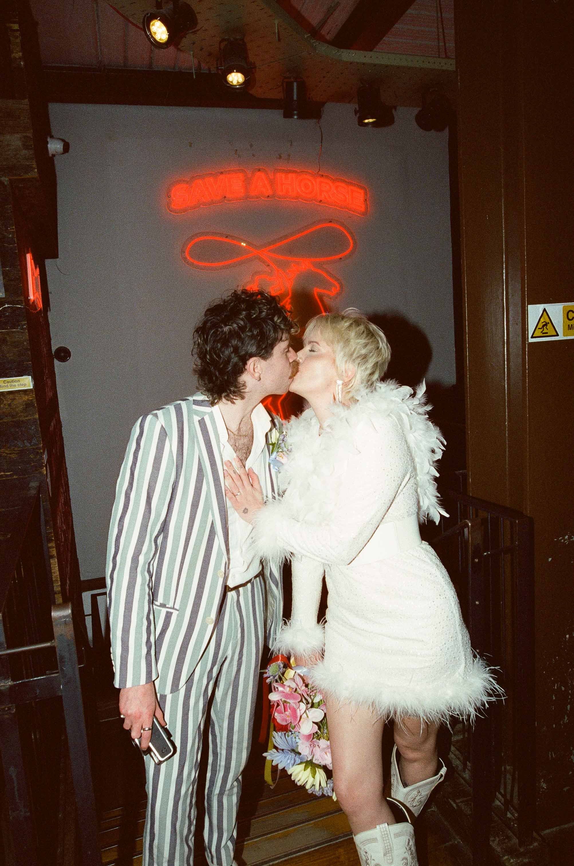 Bride and groom kissing in a 35mm film wedding photo