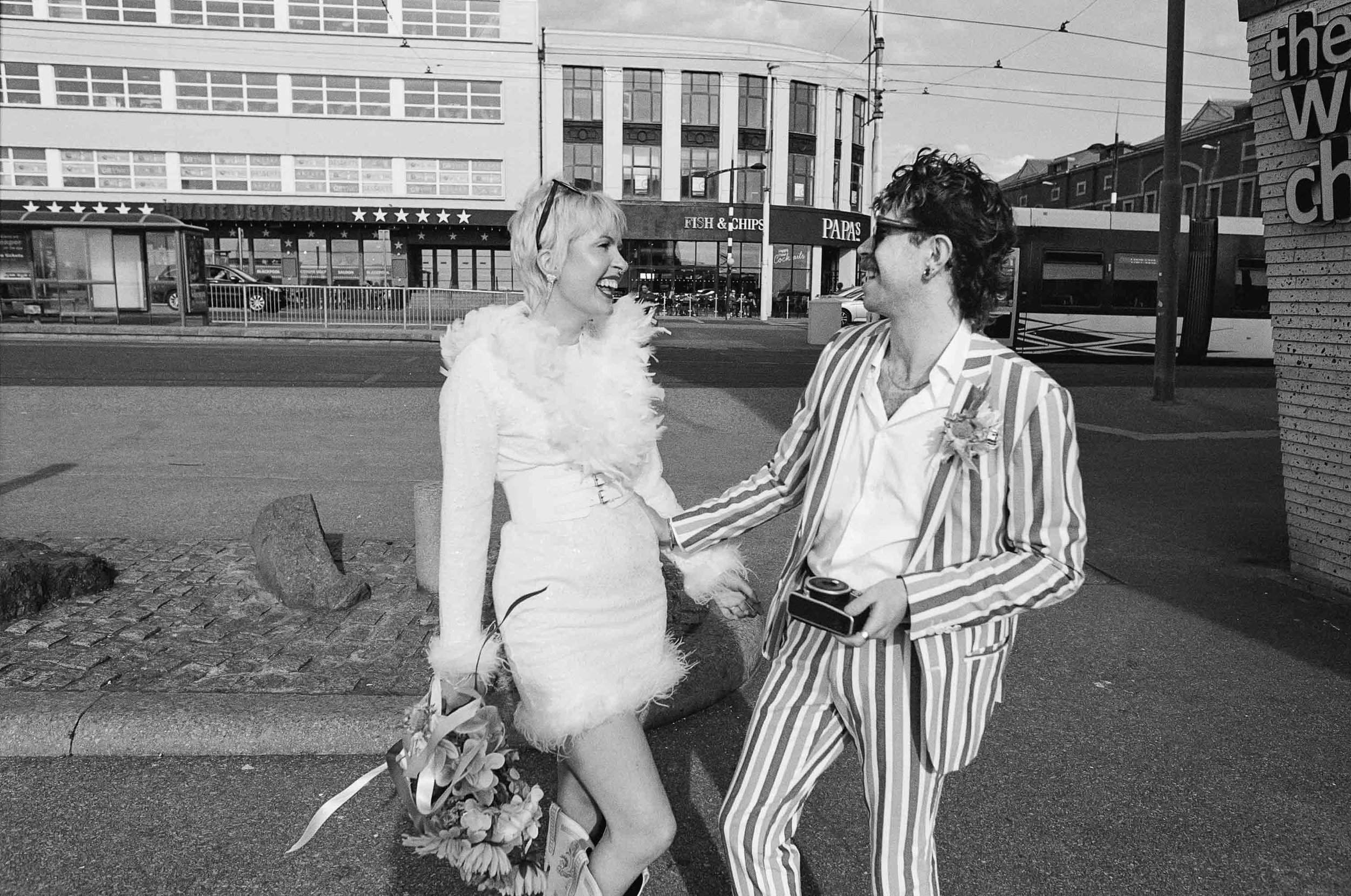 Bride and groom laughing naturally in a 35mm film wedding photo