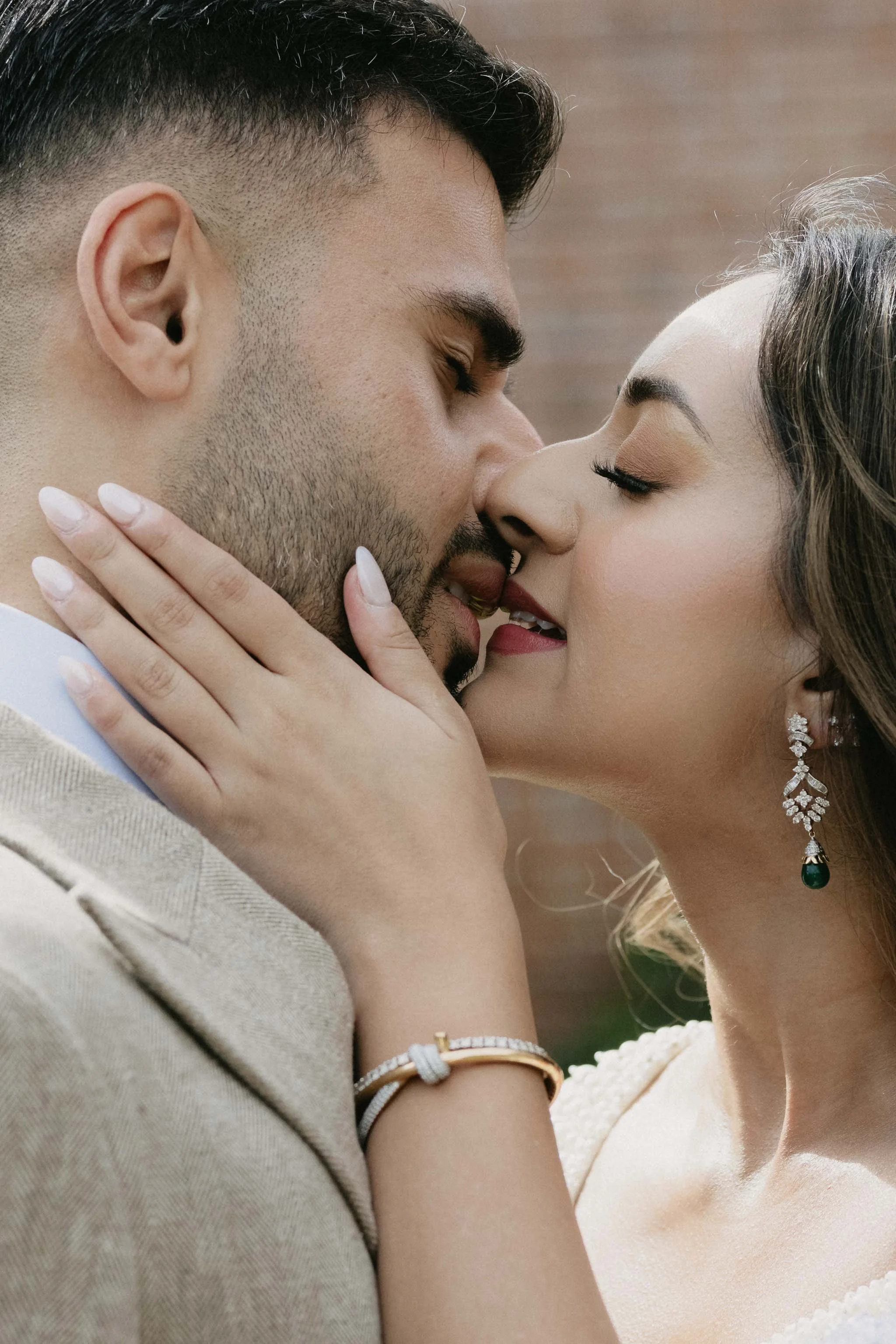 Close up of a couple embracing during an engagement photoshoot.