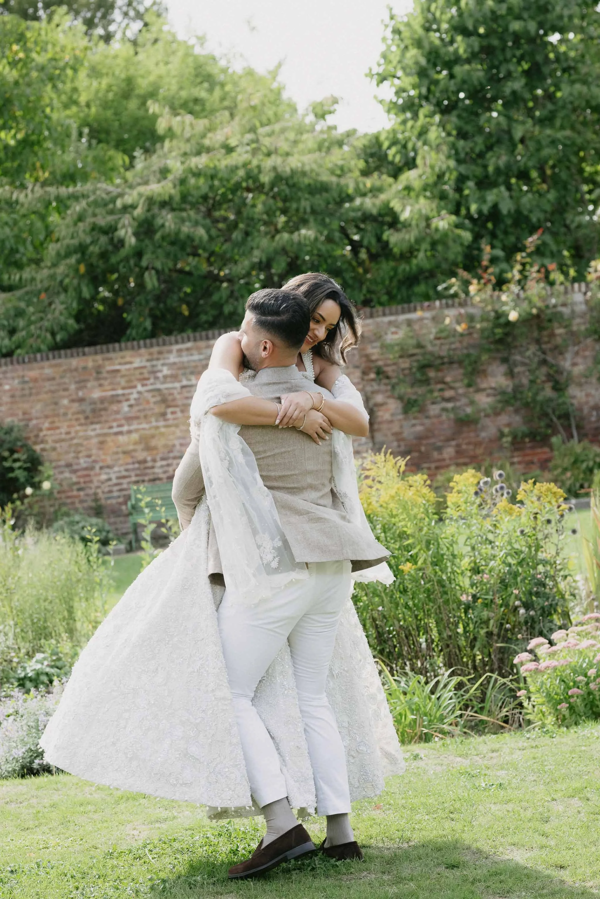 Editorial engagement shot of a couple twirling around.