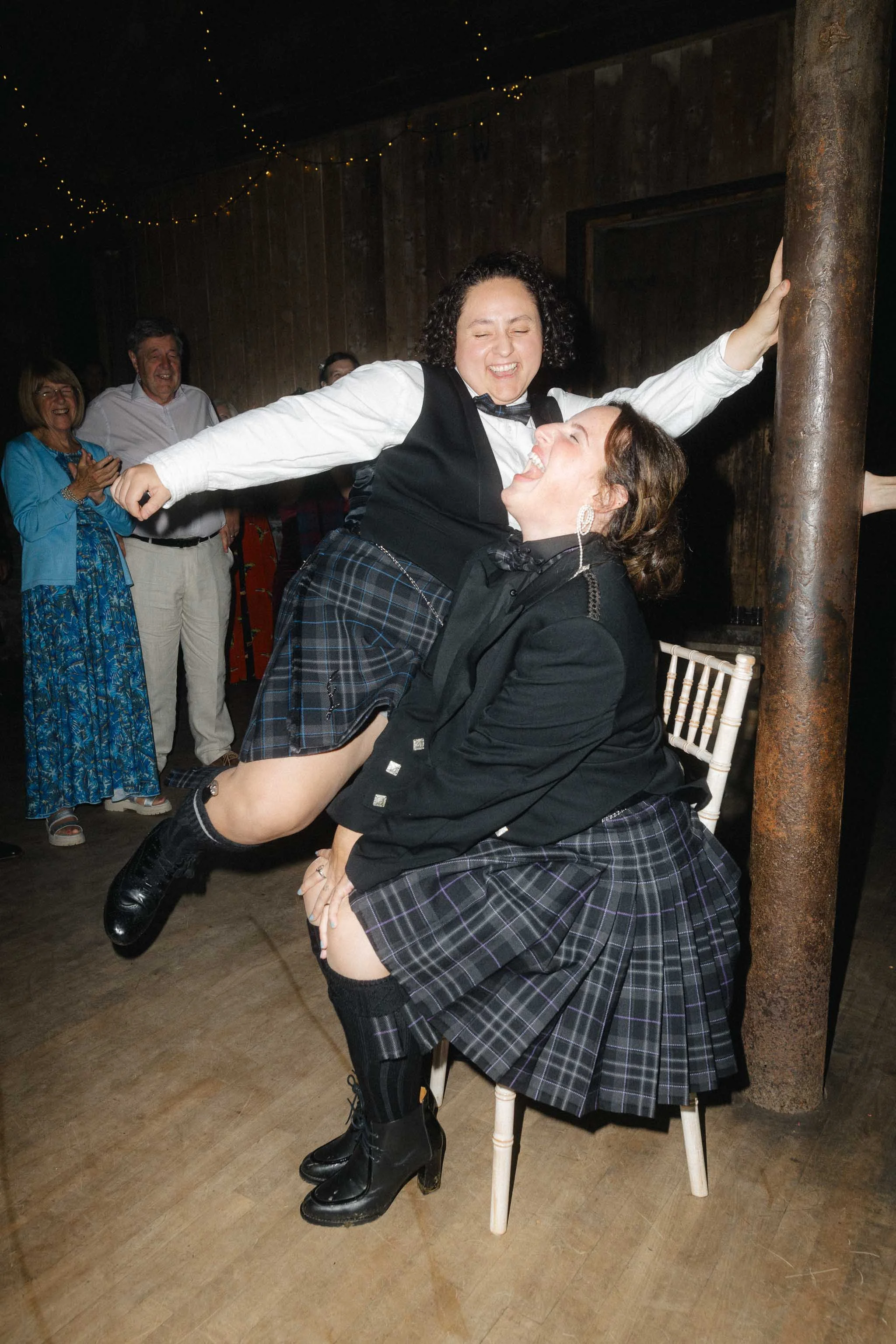  Wedding guests laughing during a wedding reception. 