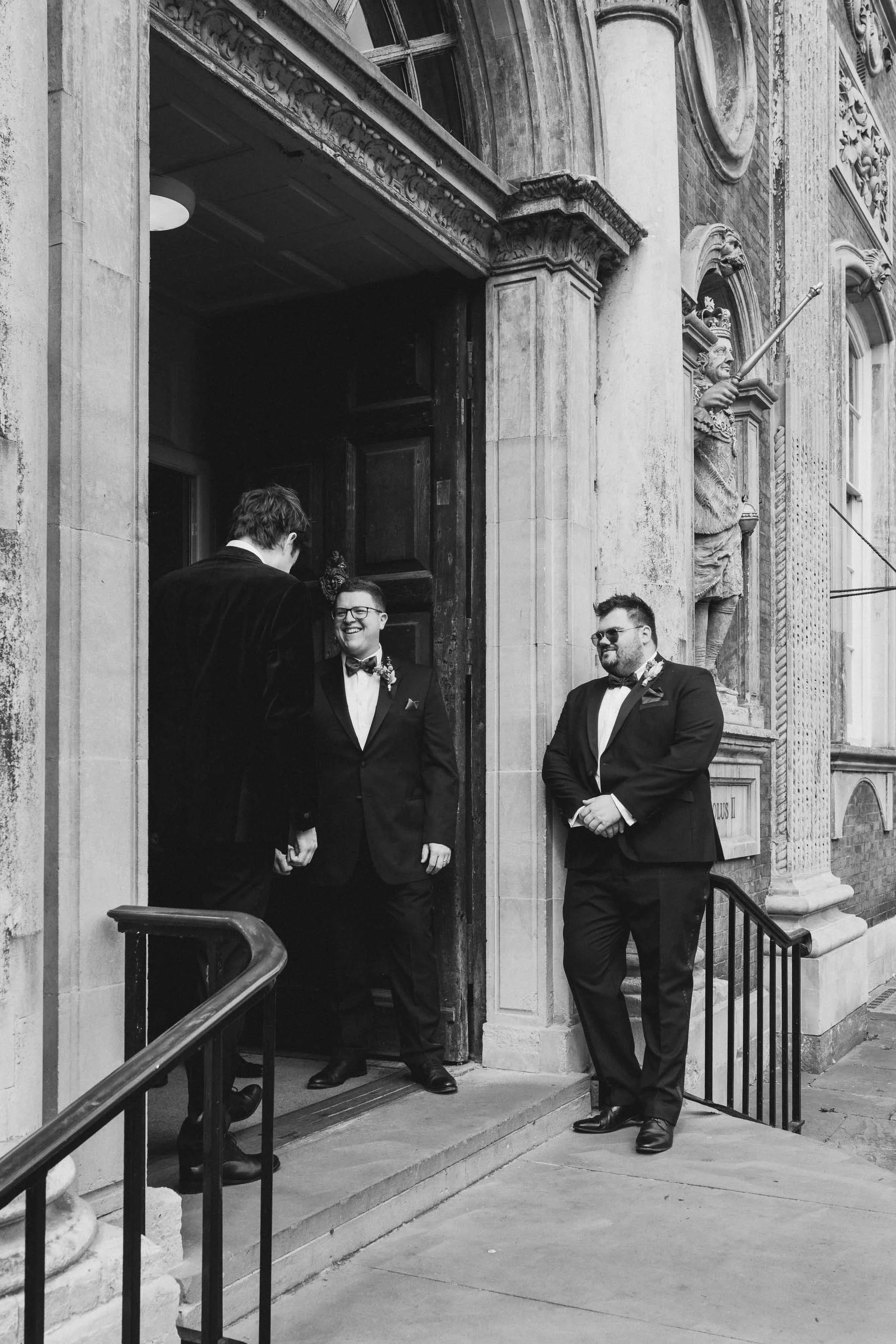  Groomsmen waiting on the steps of Worcester Guildhall. 