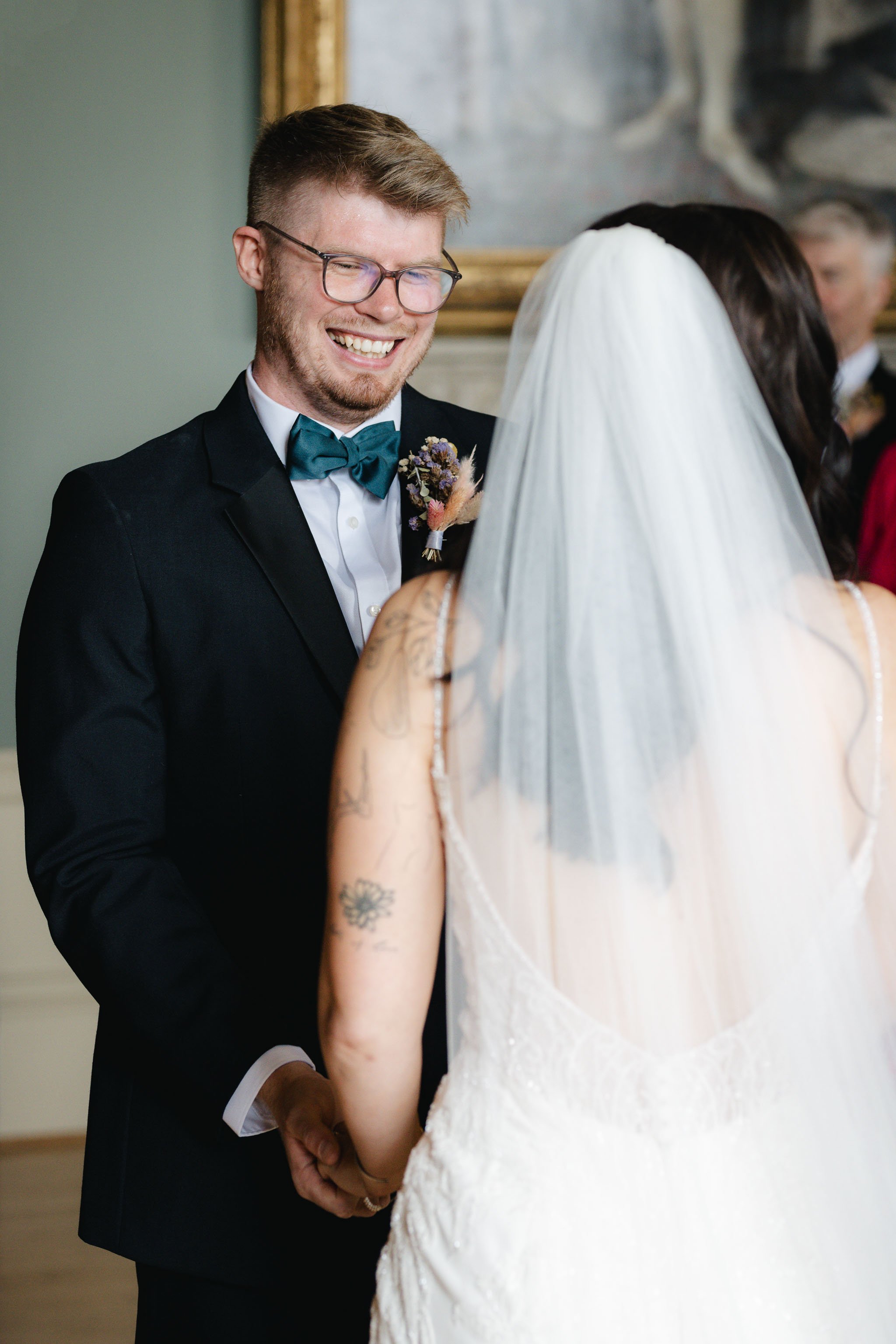  Groom looking at bride during wedding ceremony at Worcester Guildhall.  