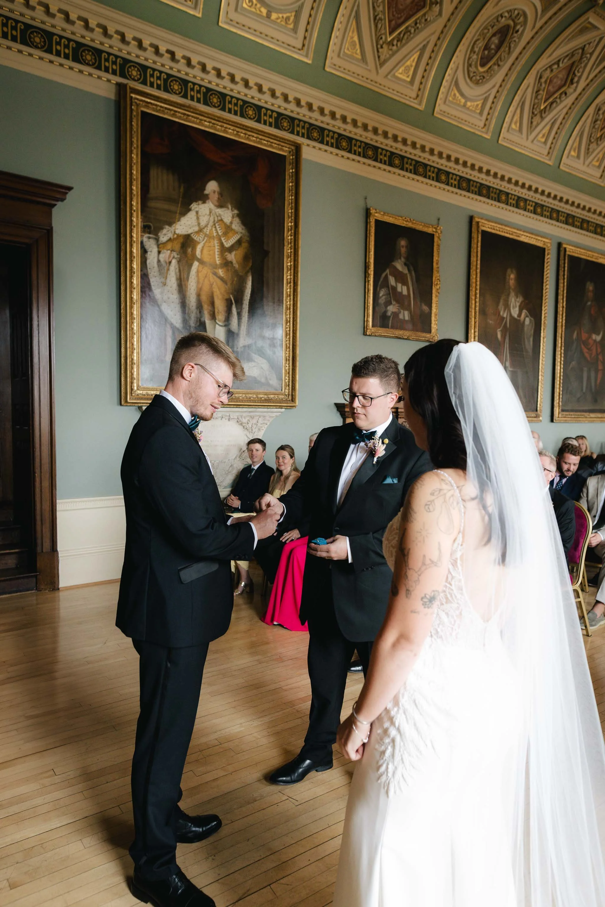  Best man handing over rings during a wedding ceremony at Worcester Guildhall. 