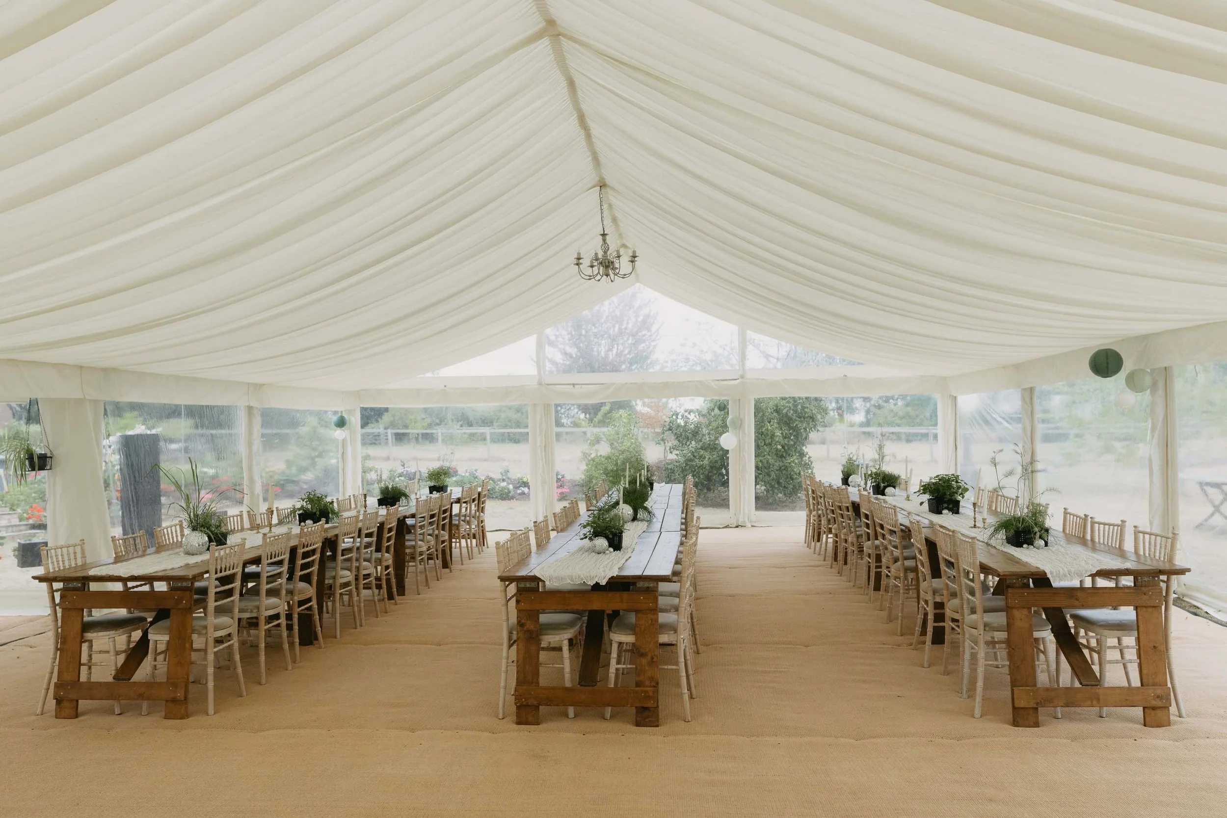  Marquee wedding reception at home with playful decorations and lights. 