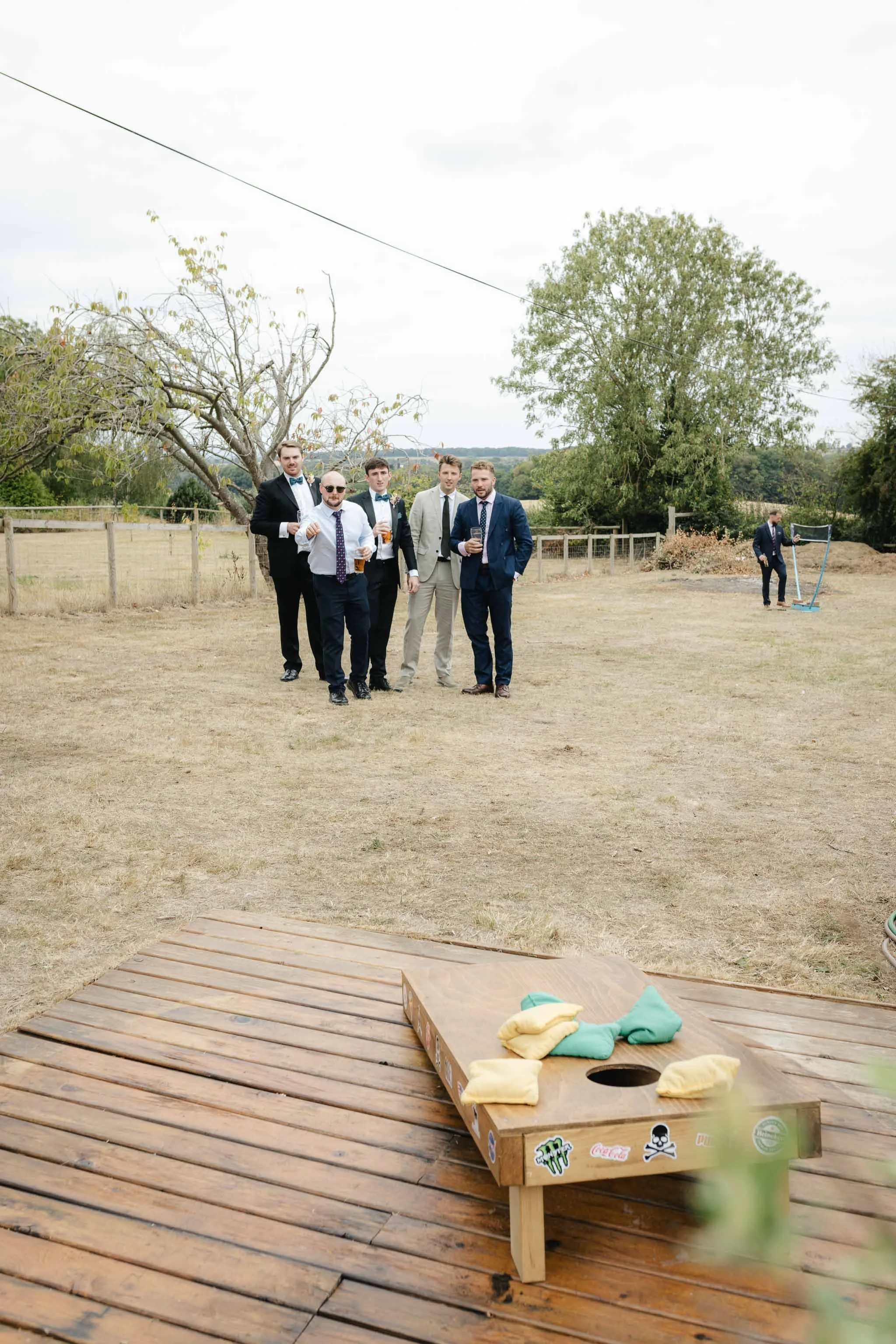  Wedding guests playing lawn games at a backyard wedding reception in Worcester. 
