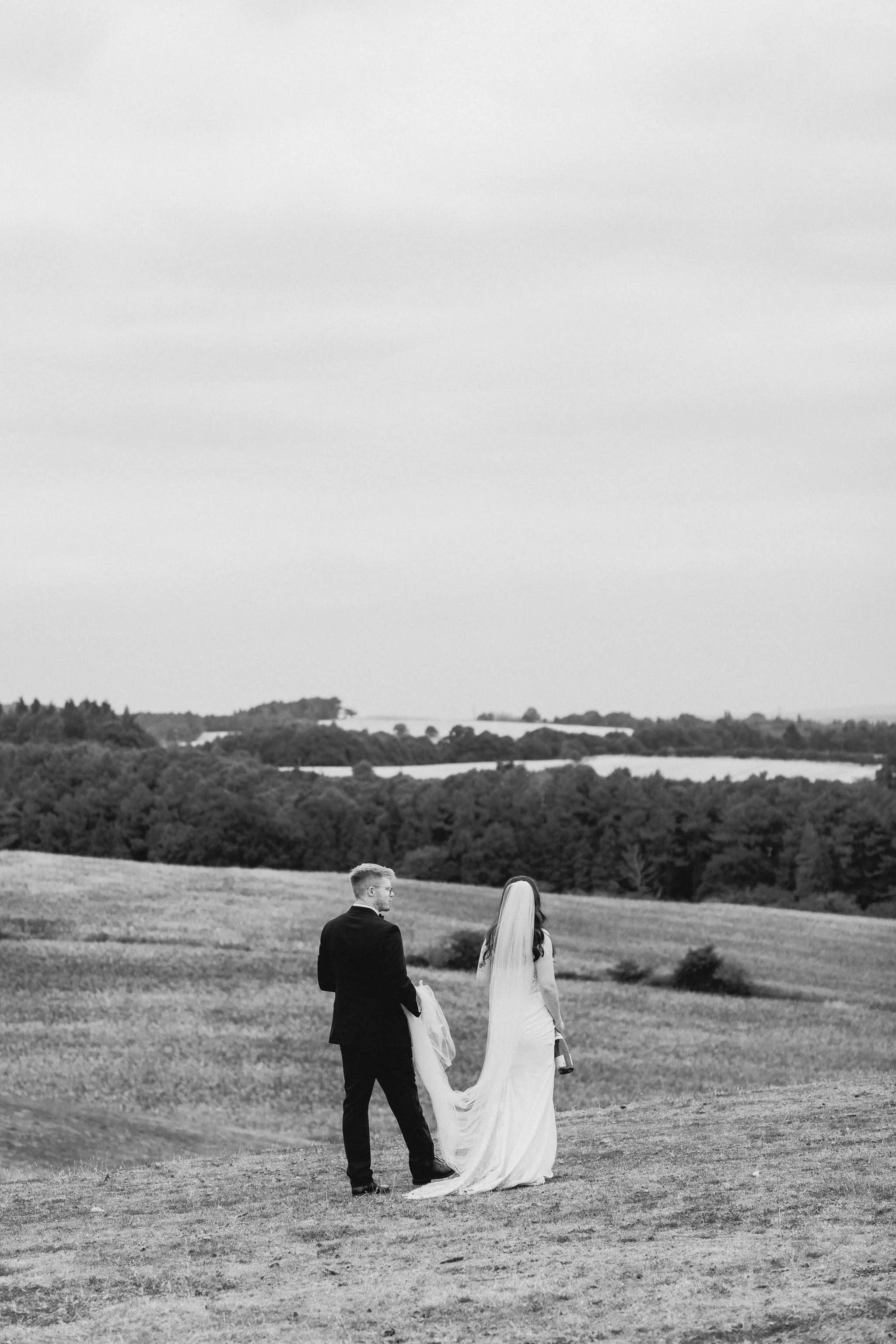  Bride and groom portrait outside walking at a backyard wedding reception in Worcester. 