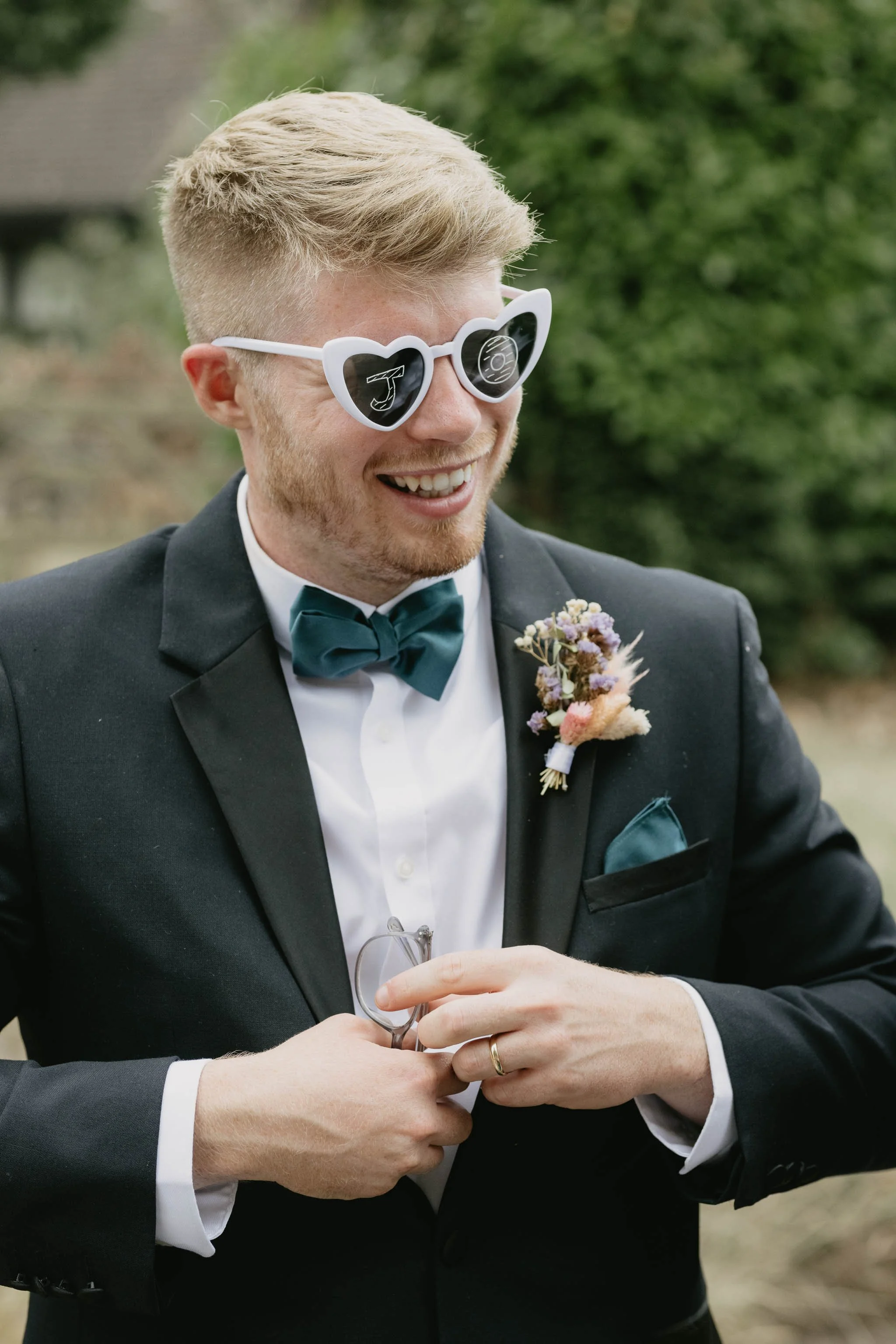  Groom smiling wearing sunglasses at a marquee reception in Worcester. 