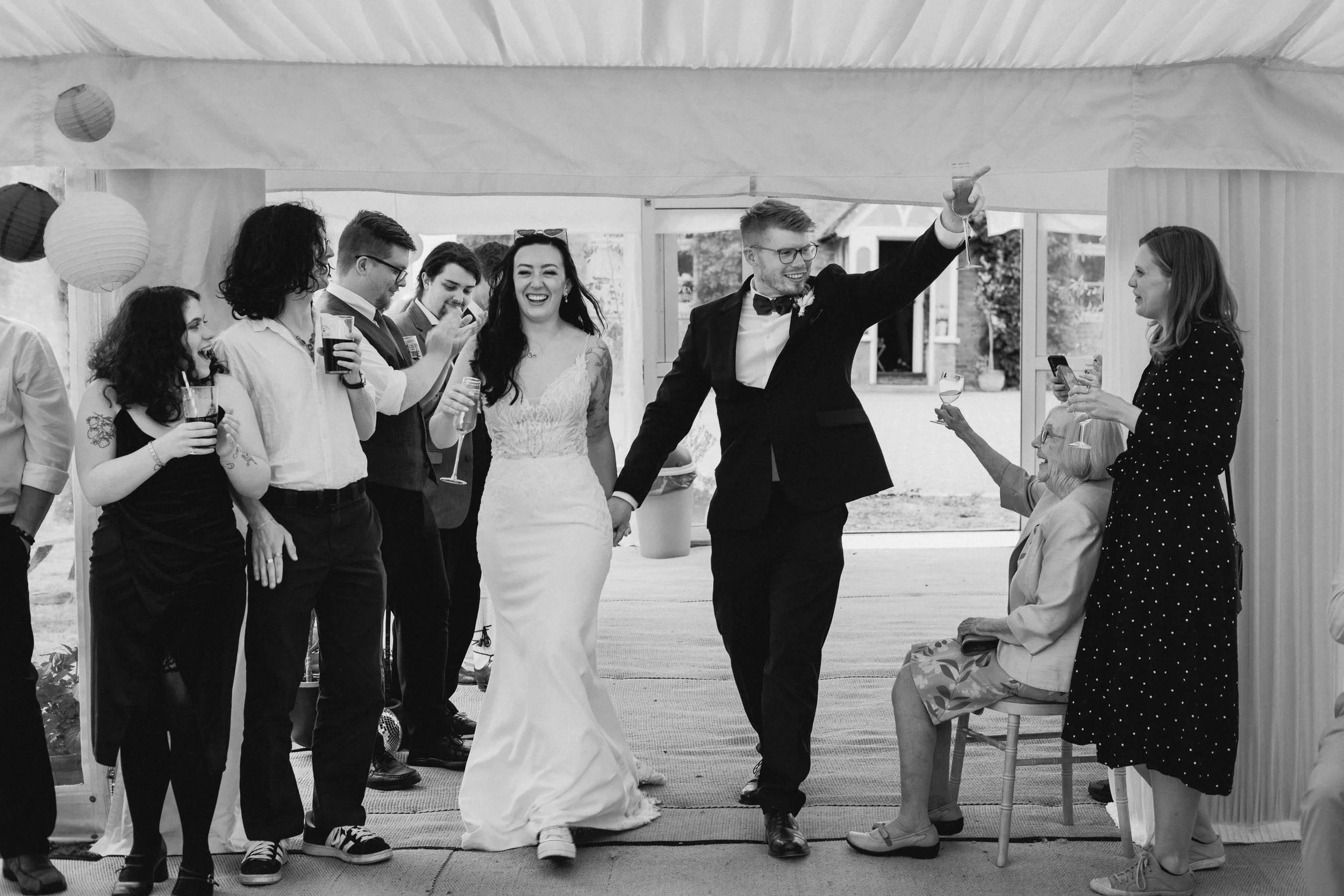  Bride and groom entering a marquee wedding reception. 