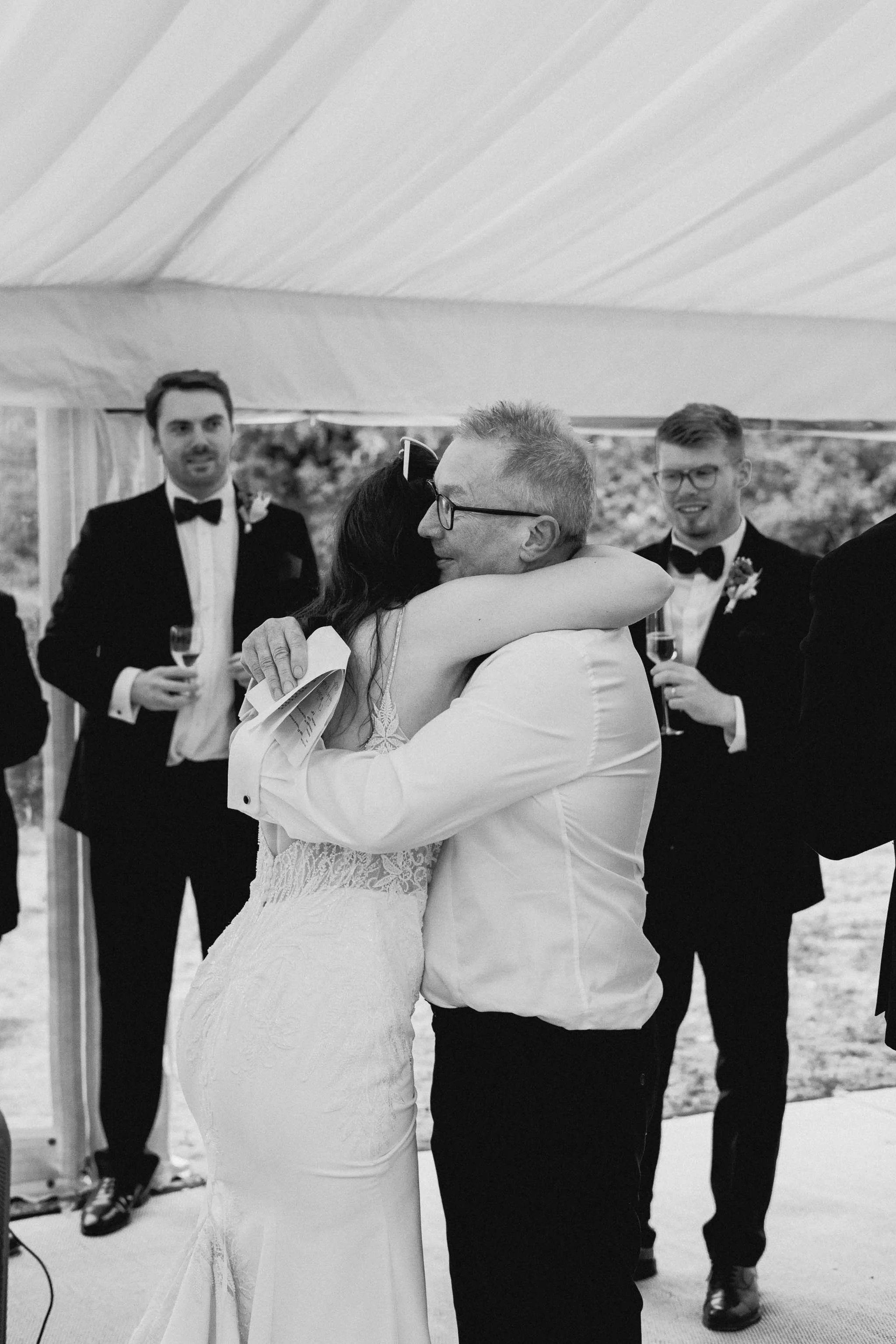  Bride hugs her Dad during speeches at a marquee wedding at home in Worcester. 