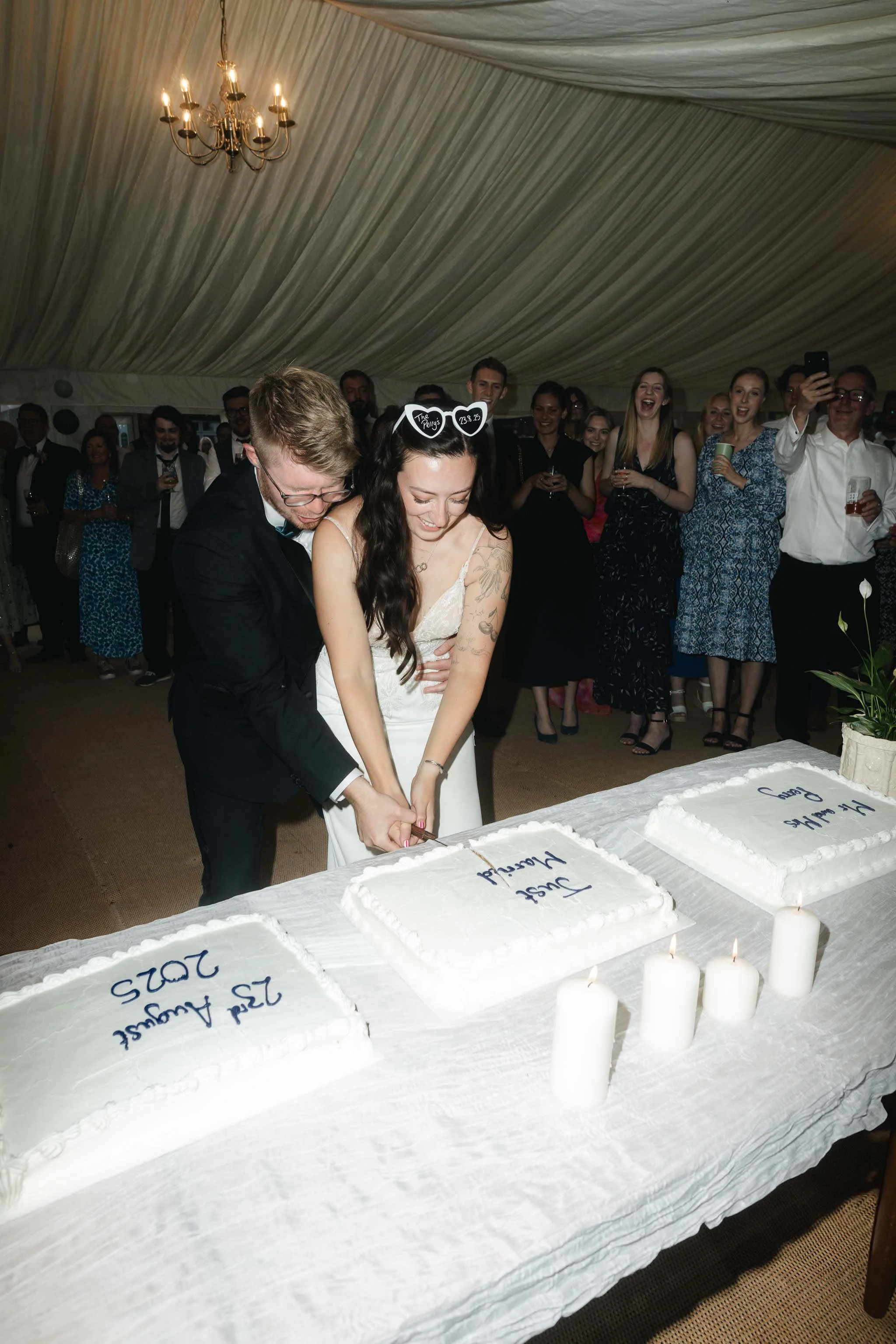  Jess + Oli cutting their wedding cake at home marquee reception in Worcester.   