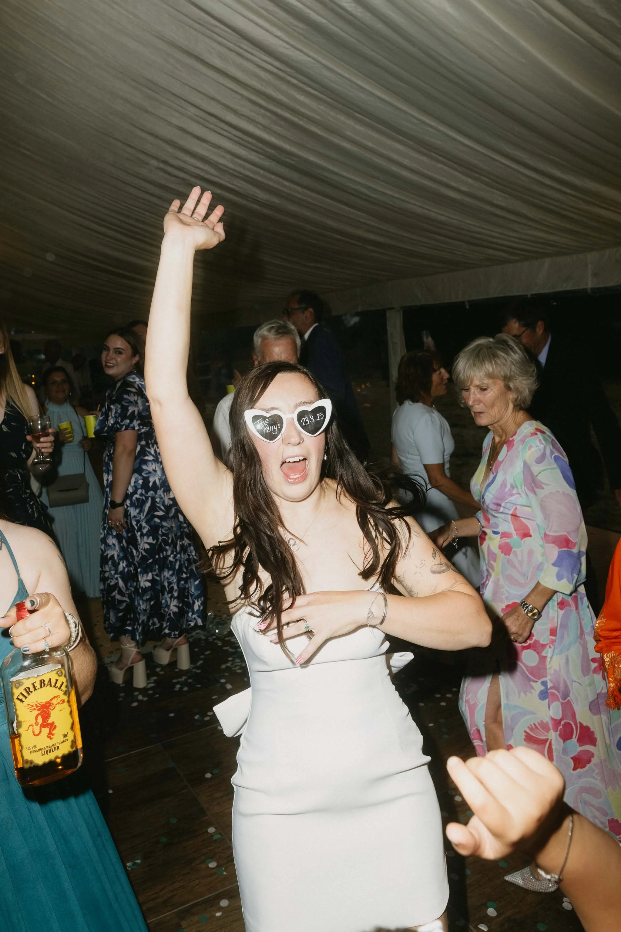  Bride dancing with arm in the air at a backyard wedding reception in Worcester. 