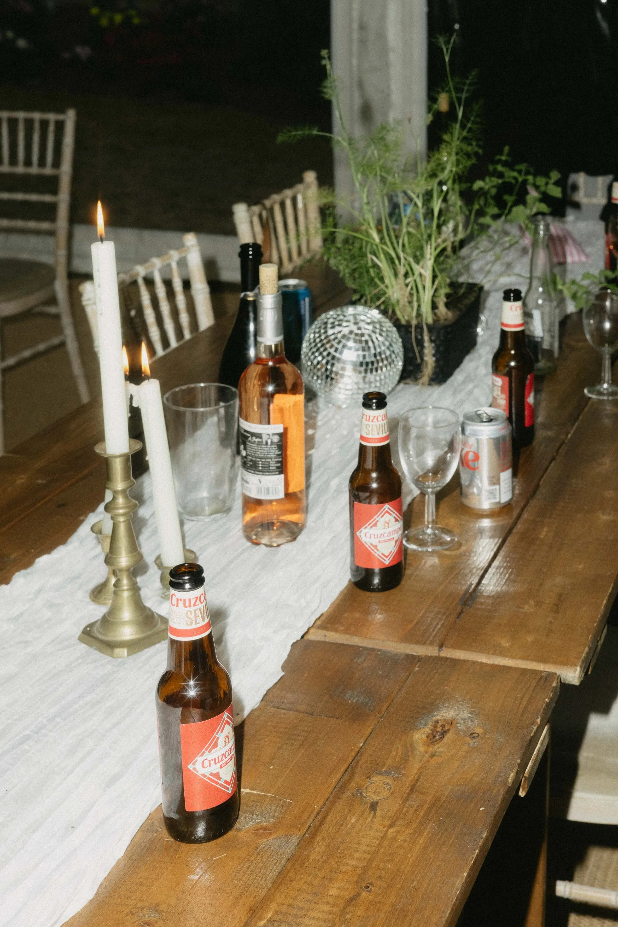  Empty bottles on a table at a marquee wedding reception.  