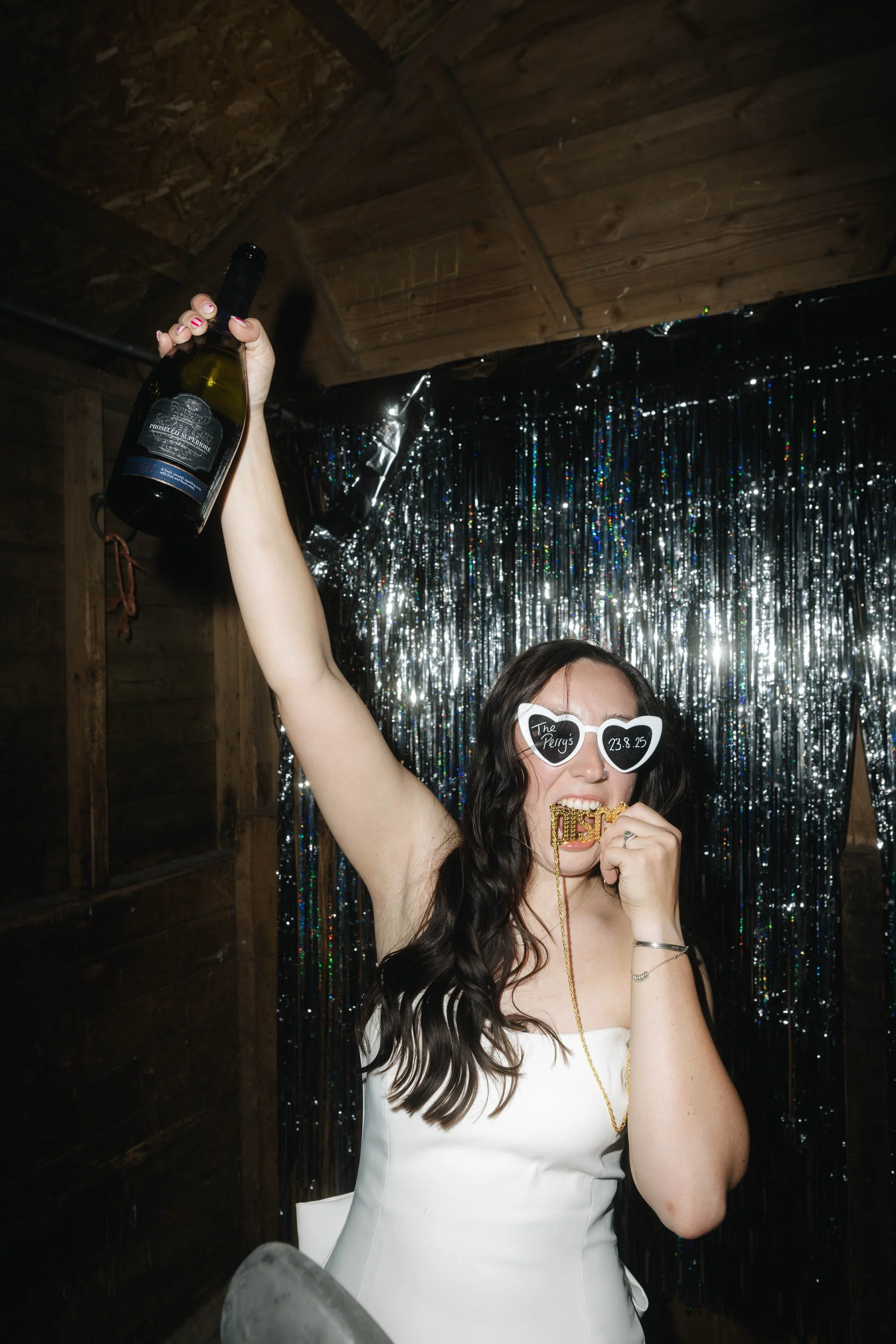  Bride poses for a fun editorial photo with sunglasses. 