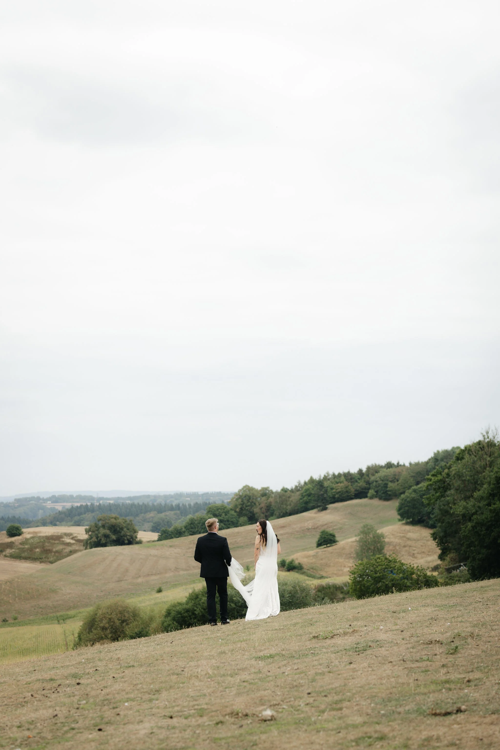  Bride and groom walking in the distance at a backyard wedding reception in Worcester. 