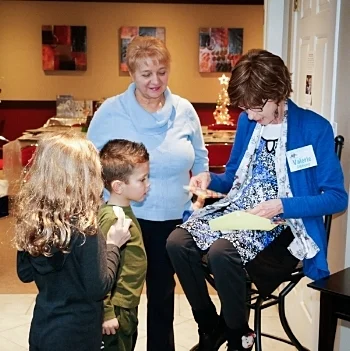 Young visitors go home with smile stickers after learning about the mission of FootsieStools Ltd. at an open house at the White House art studio.