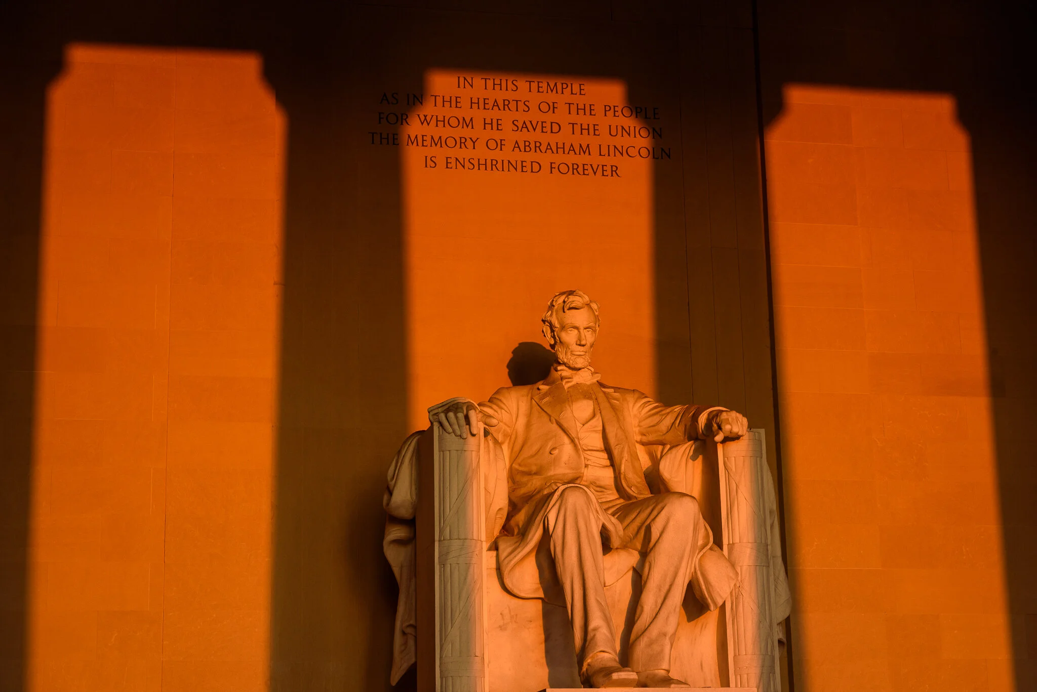 Warm colors of sunrise shine into the Lincoln Memorial during the Spring Equinox in Washington, D.C.
