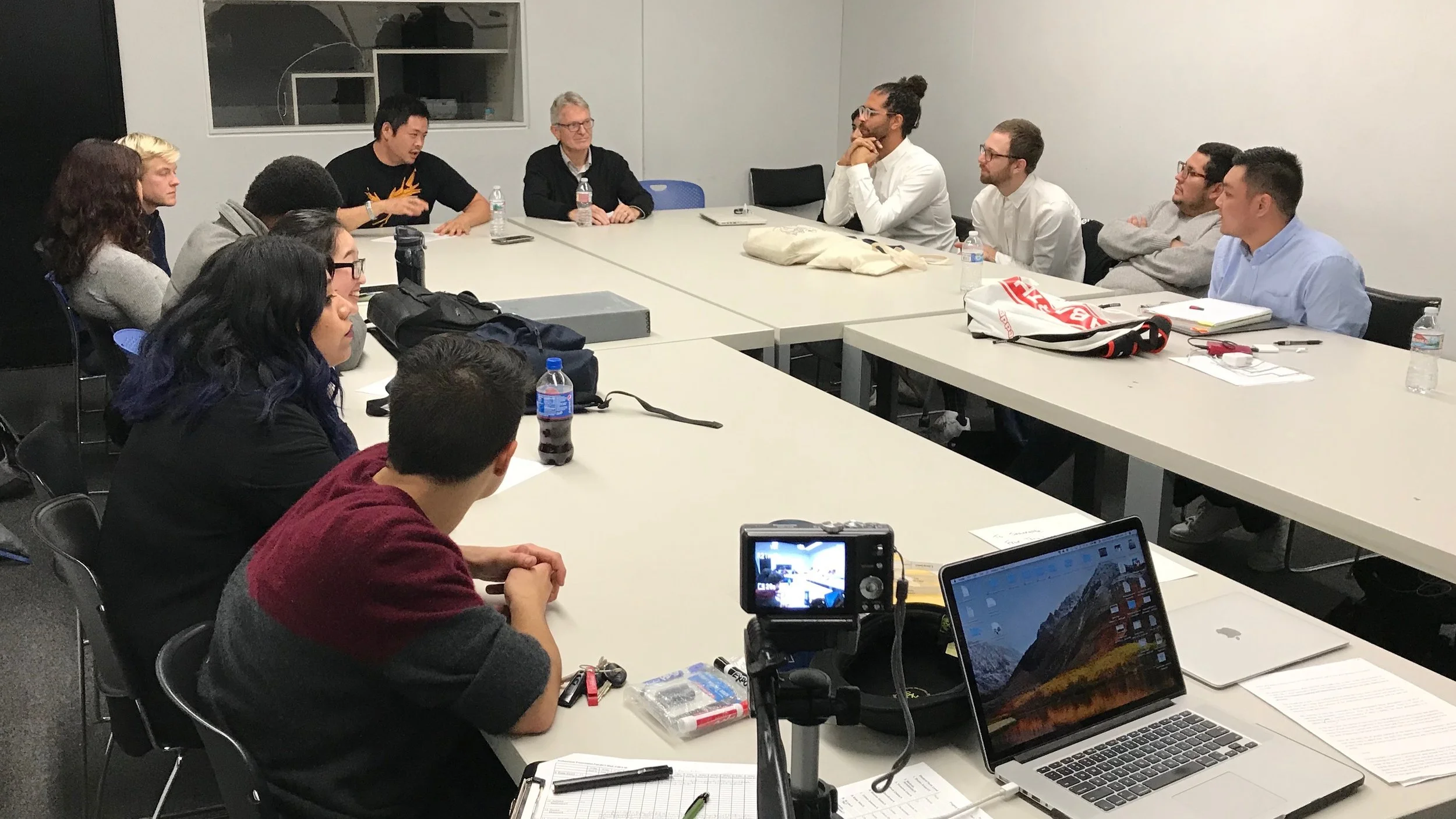 Nathan See and Lawrence Crandall (center top) give valuable instruction to students during the Art Center Professional Presentation class final presentation.