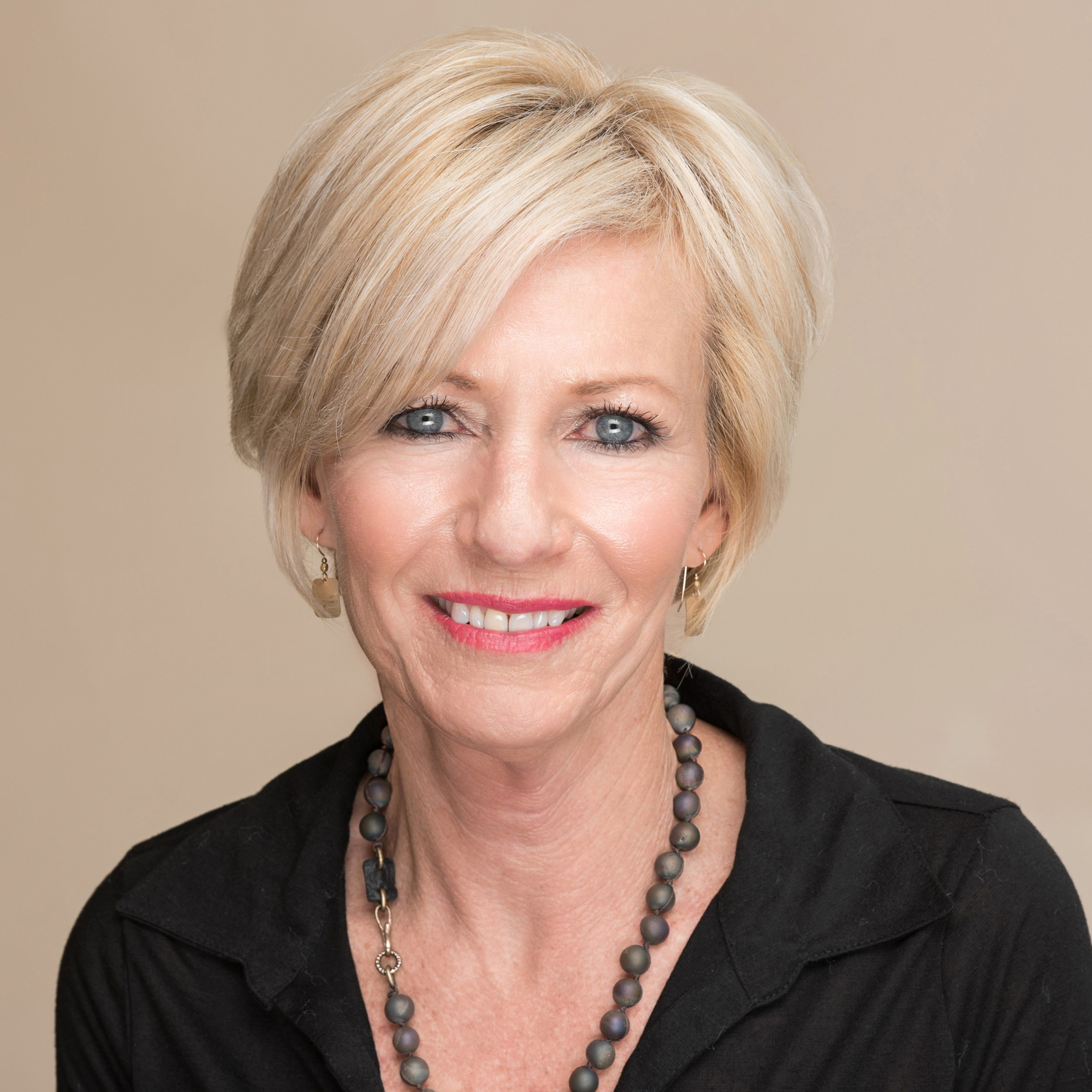 Professional business headshot of a woman using studio light.