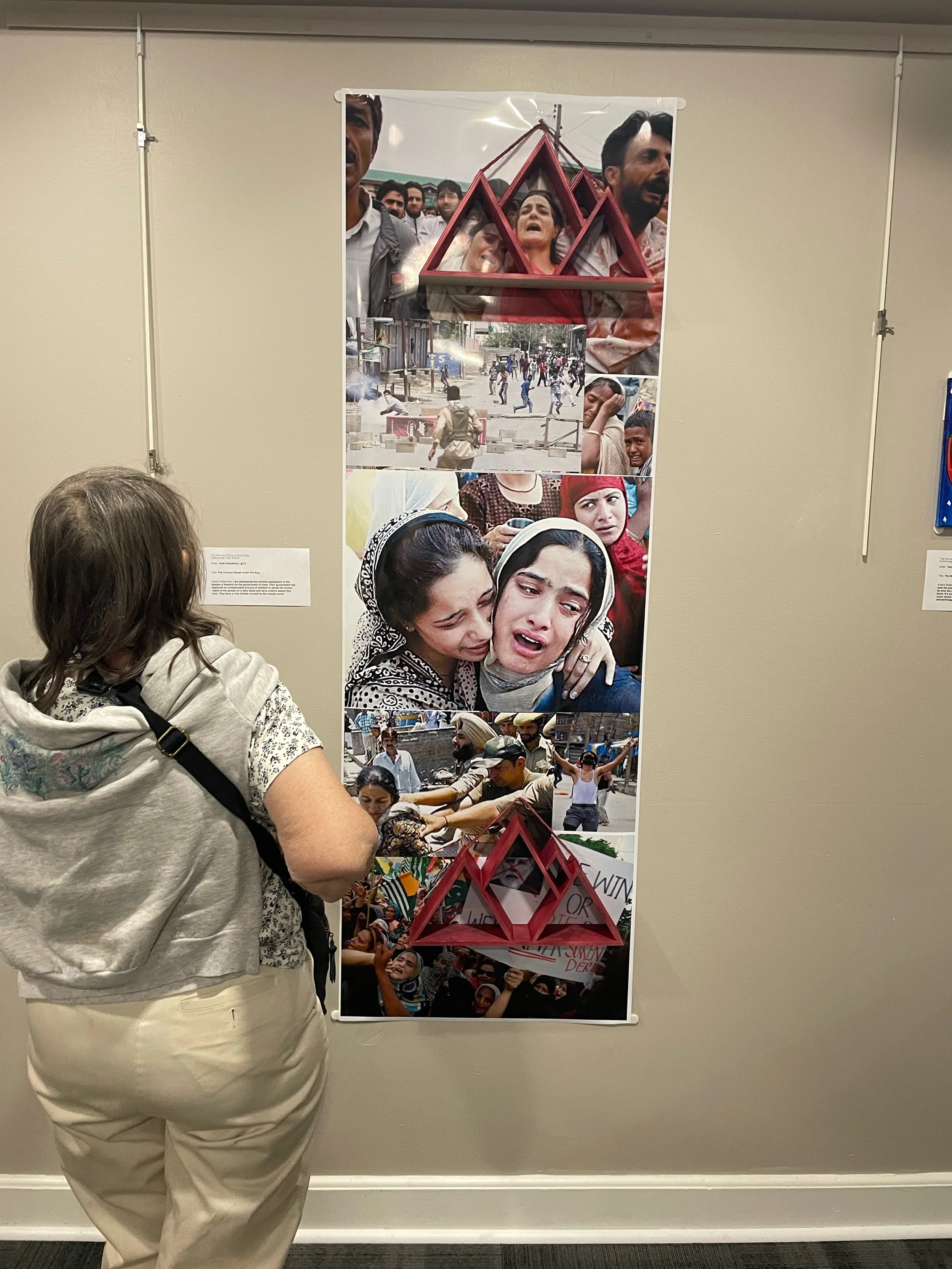 Looking at student work in art exhibit