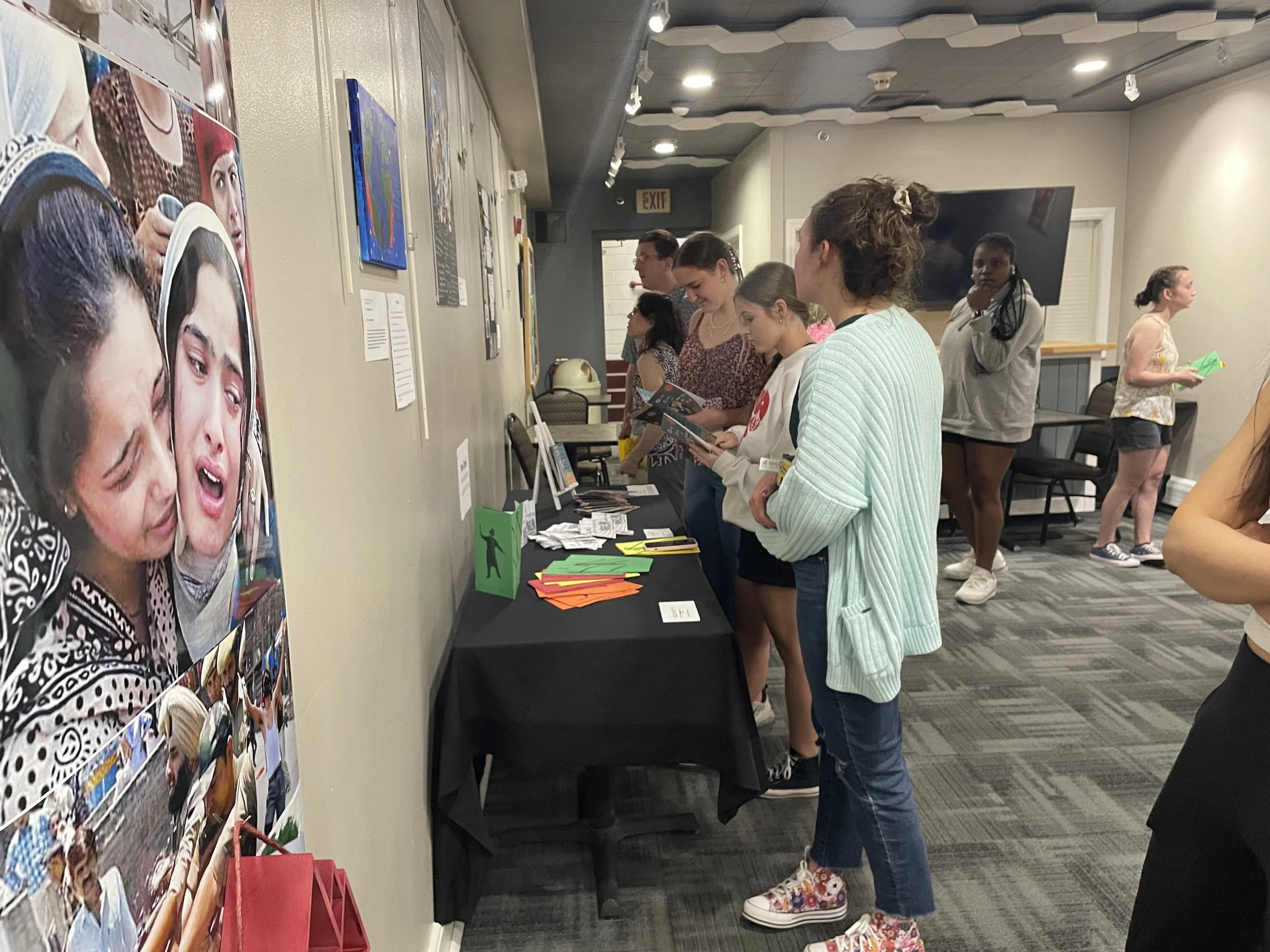 Looking at student work in art exhibit