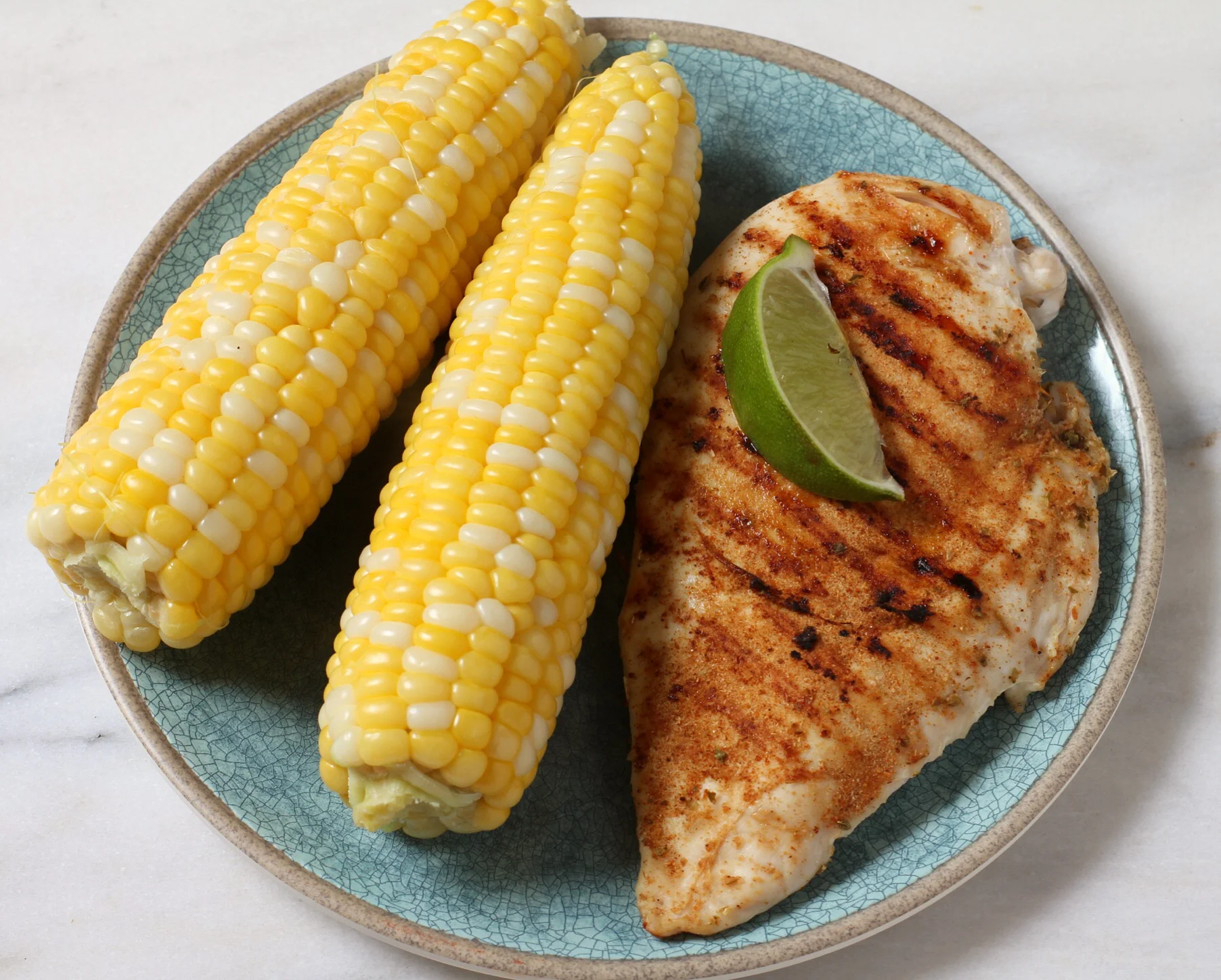 Corn on the cob and pan-grilled chicken. Lime wedge just for fun.  