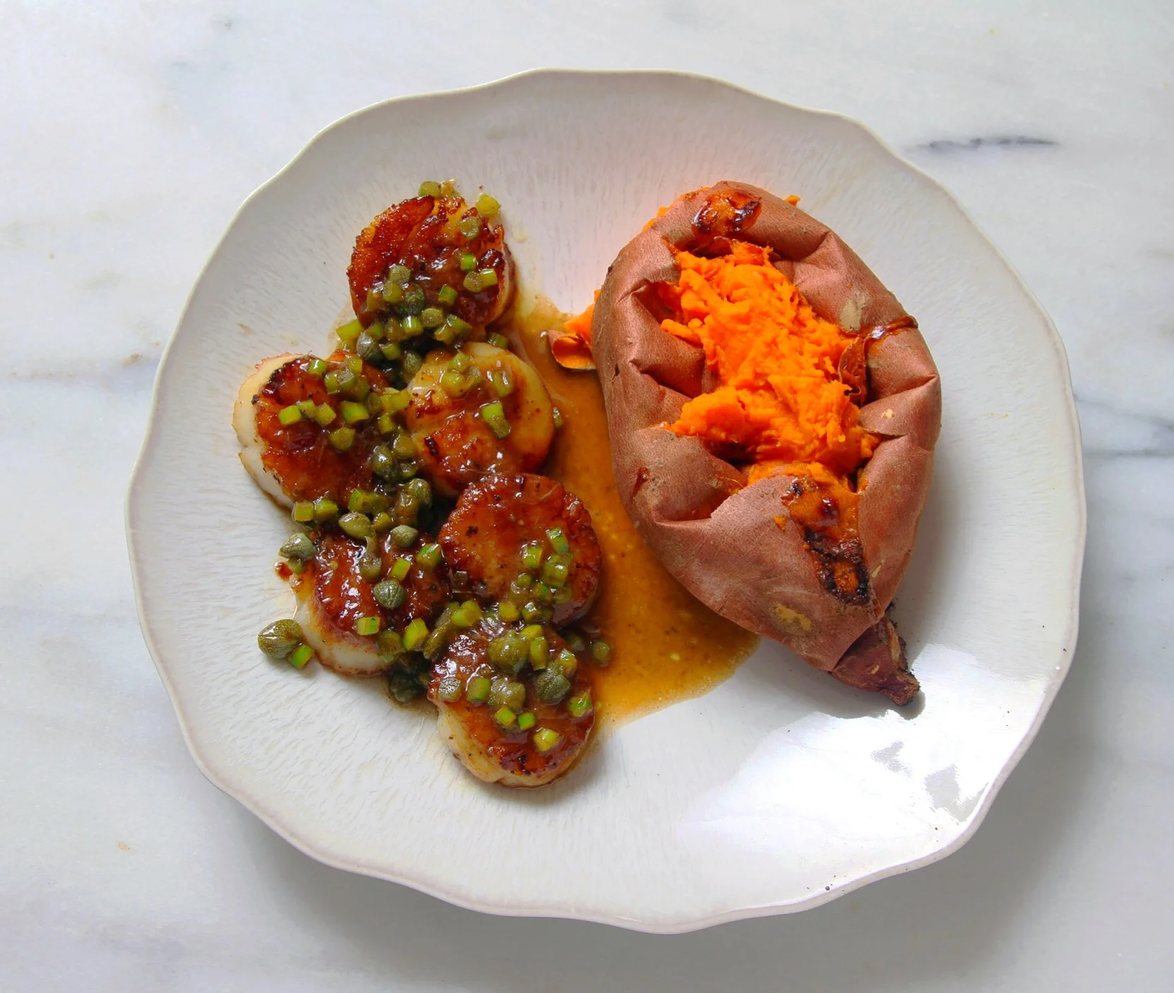 Seared scallops with brown butter and lemon pan sauce; baked sweet potato on the side. 