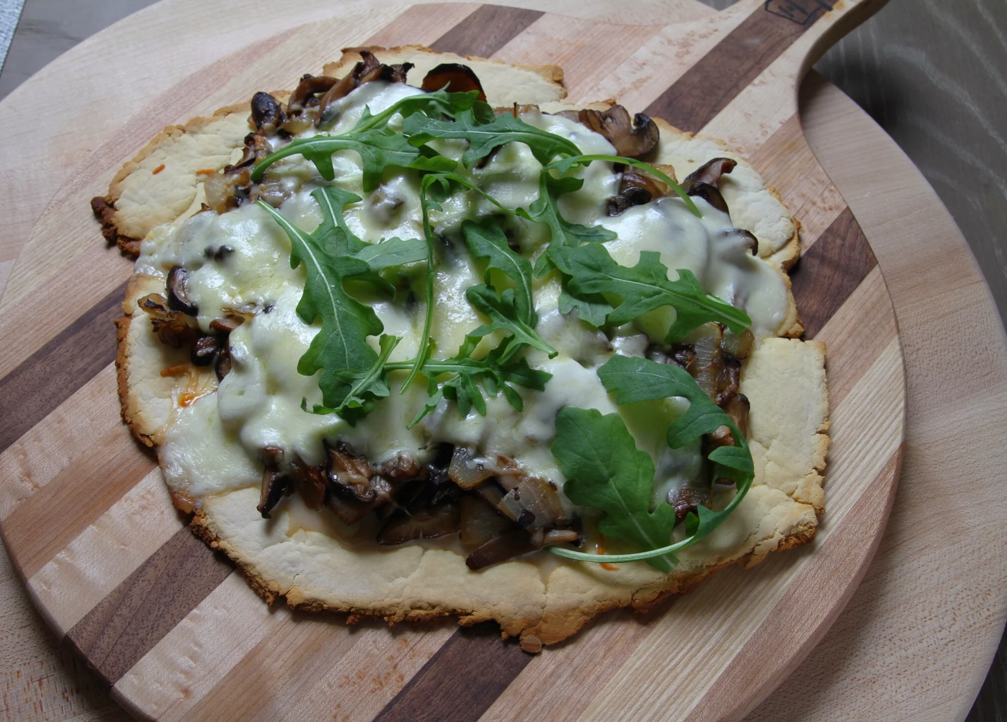 Sautéed mushrooms and onion pizza with mozzarella and arugula. Cup4Cup crust, worked well for this specific pie.  
