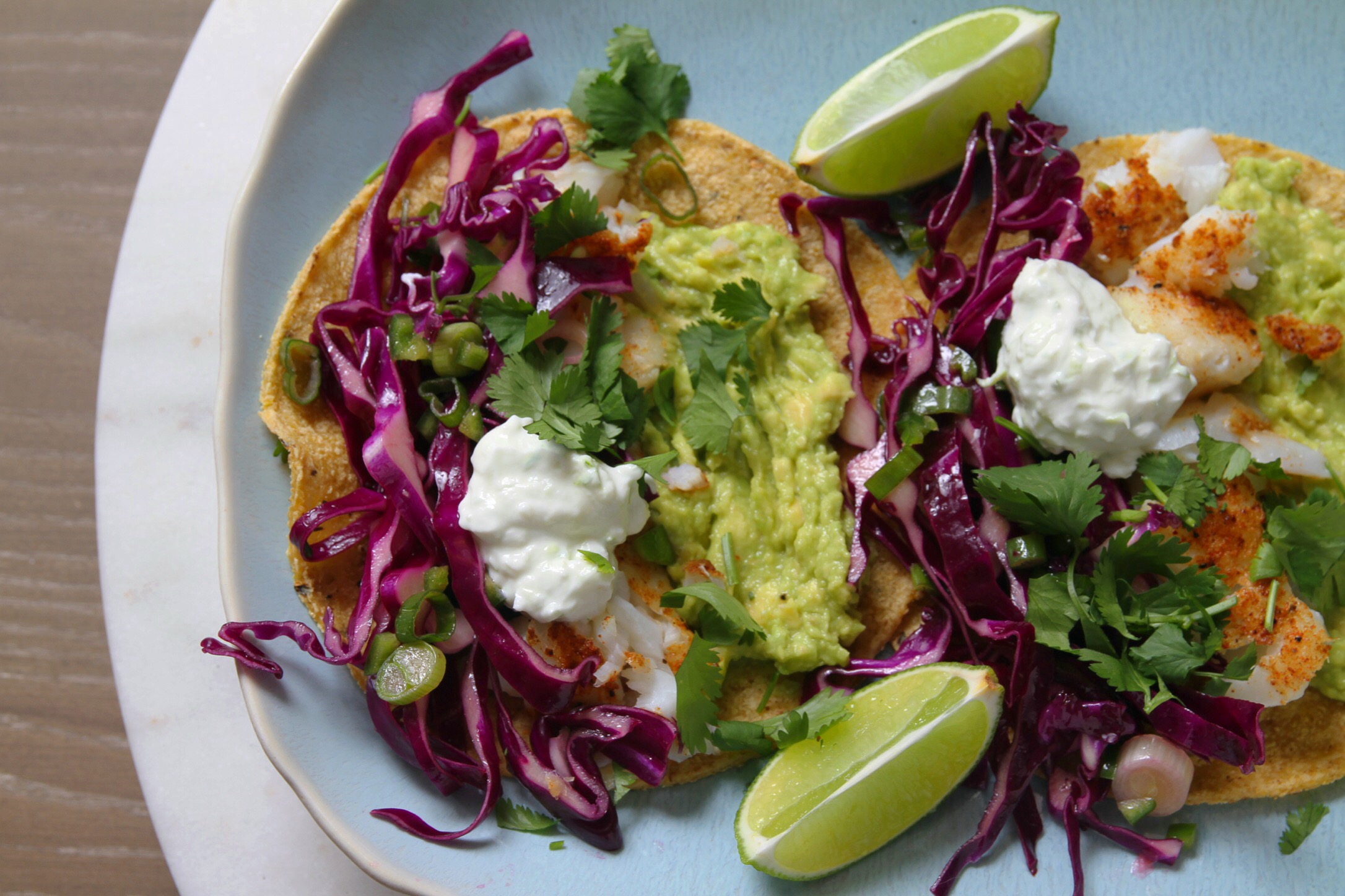 Fish tacos with cabbage slaw,  crema, and avocado.
