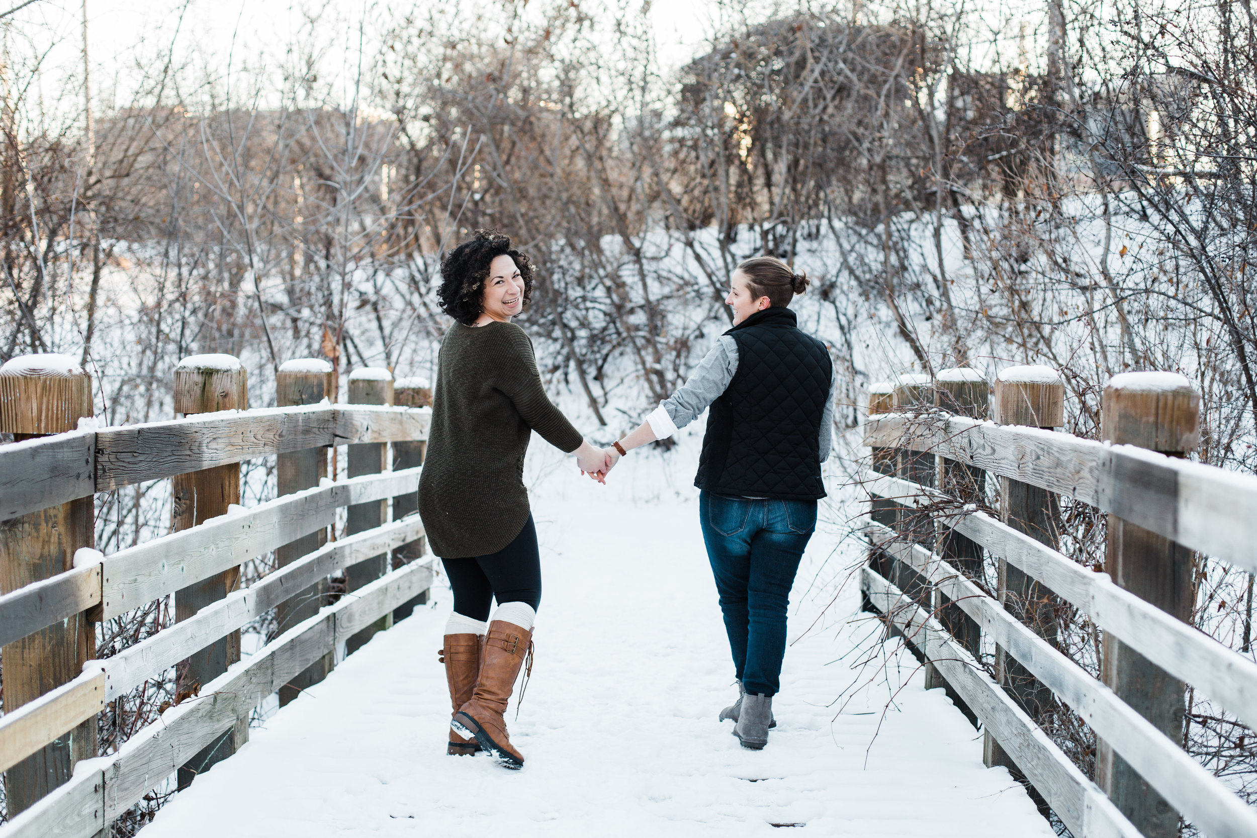 Winter engagement photos, winter bridge engagement photo, LGBTQ engagement photos, fun engagement photos, engagement session inspiration, snowy engagement photos