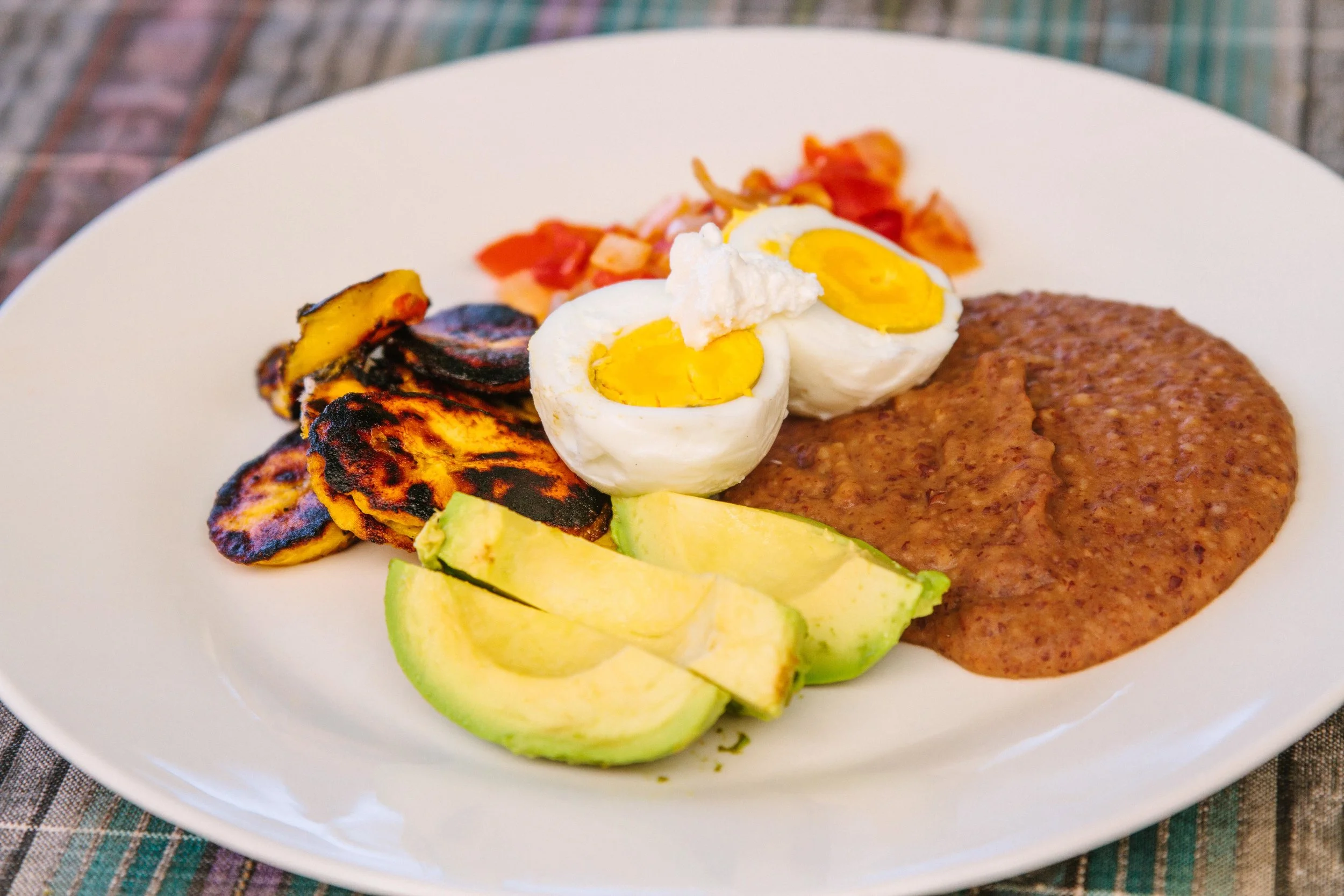 Plate with eggs, beans, avocado, plantains, and red sauce. Delicious breakfasts served at the Discovering Birth Midwifery Retreat at the Bambu Guest House, Lake Atitlan, Guatemala, July 14-27, 2019