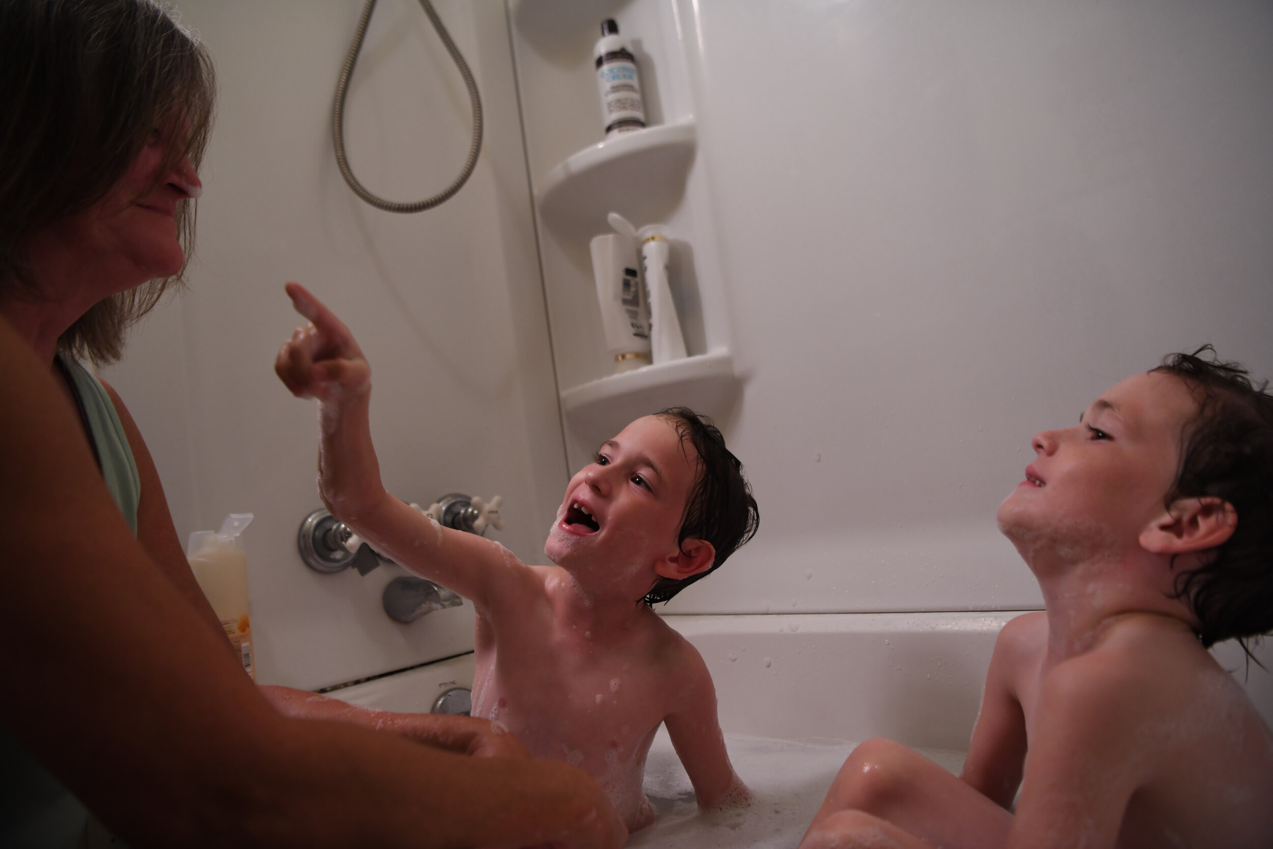  Riley (left) and Garrett (right) play with Alice during their evening bath. 