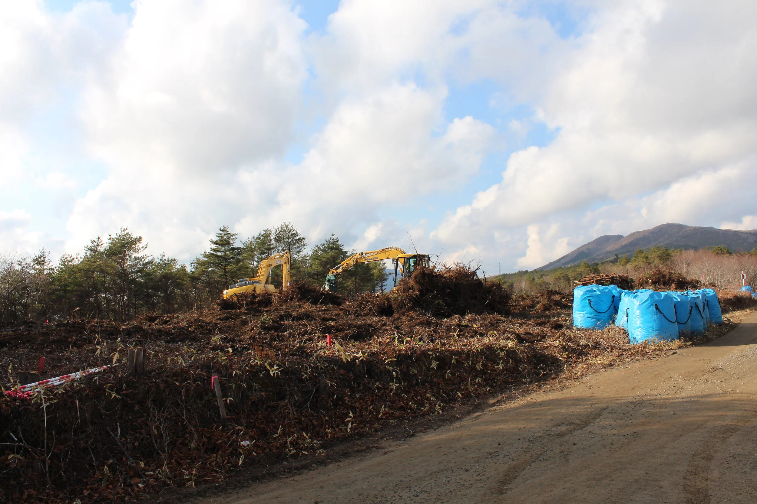 Scooping up radioactive top soil and blue-bagging it.JPG