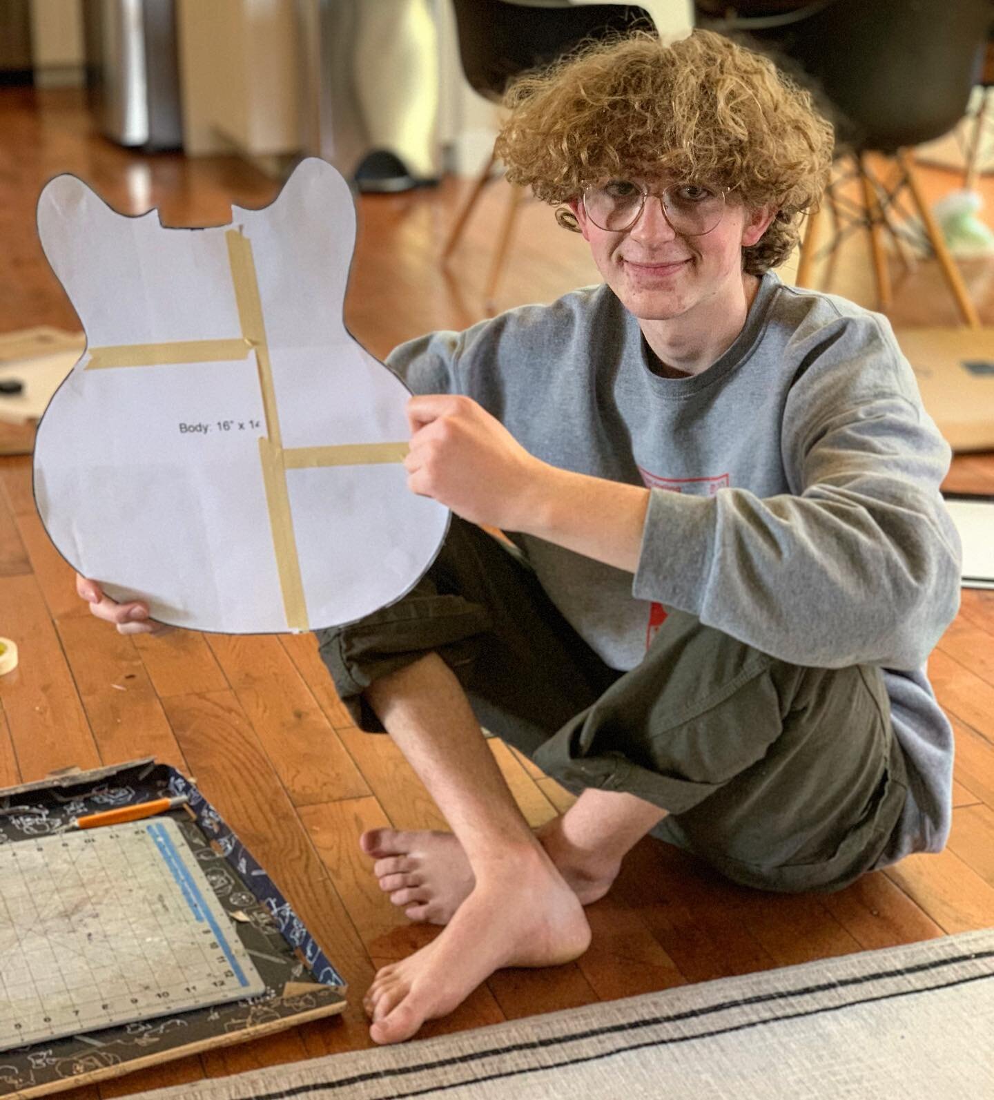 This guy has decided to make an electric guitar in shop class. What he&rsquo;s holding is one part of his cardboard prototype, which he&rsquo;ll use to pitch the project to his shop teacher. He is also researching Leo Fender&rsquo;s original wiring d