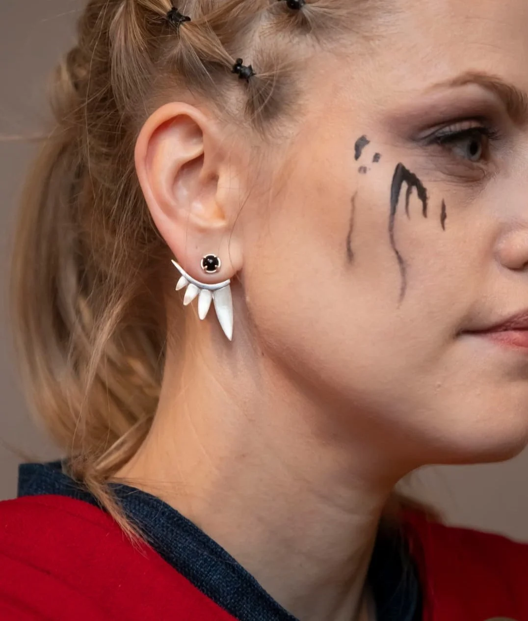Wolf Collection Carnassial ear jackets and fang gem studs in silver and onyx modelled on female Up Helly Aa viking warrior