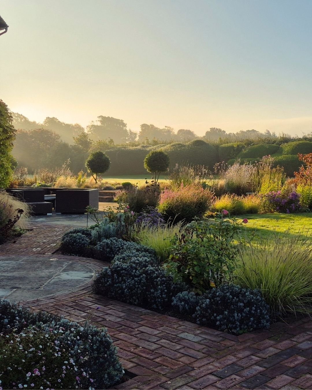 A recent photo of our client's garden sent to us by their gardener Julia, who beautifully manages a few of our client's gardens for us. She also sent through a photo from the summer, hightlighting all the colours! Our client is hugely happy with his 