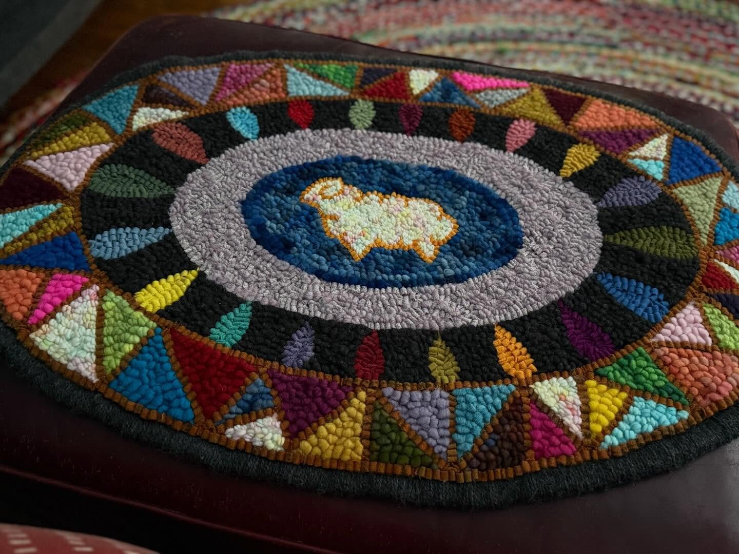 I never posted a completely finished photo of my Sheep Mosaic Mat I made for TIGHR over the past couple of months. I decided to put it atop my living room ottoman. I usually have a tray for drinks on top but sometimes a cat claims the rug as a great 