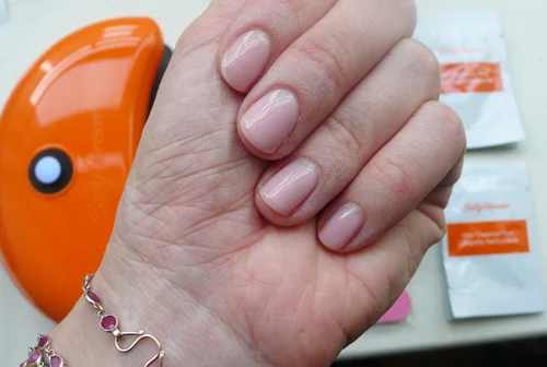 Look what I did you guys … my very own gel manicure (also, a red pedicure, not shown)! This is my new jam.
I used to get manicures sometimes 2x a week (?!). I look back at those days from my current time-for-nought, cheapskate vantage point and ask myself why I wasn’t the HAPPIEST PERSON ON EARTH during the years ~2004-2009. One thing’s for sure: I had a lot of time on my hands - LIT'RALLY.
Anyway, those days are over. I got pretty good at doing my own nails, but I still can’t always find the time. I’ve splurged on gel manicures in the past but I don’t love the expense.
Enter these conveniently boxed items ->
Sally Hansen is pretty much my gold standard when it comes to product innovation for nail, and I swear by their Salon Effects nail polish stickers , so I had a good feeling ( that’s why I accepted this sponsored post, in case you wonder how I make these decisions ). Still, I was surprised that this was so mistake-proof, really turned out nice … and lasted.
Here’s how it goes down:
First and foremost, READ THE DIRECTIONS! There are lots of tips and they’re important. Plug in the little lamp, file and clean your nails (with the enclosed wipe) and then apply the base coat. Press the little button and wait 30 seconds - the lamp turns off by itself.
Apply the color coat. I used Shell We Dance - the kit came with a burgundy red but I wanted to tiptoe into this operation. Don’t hesitate to really wipe down your nail with the brush to ensure the color is thin. It’s not like nail polish - it doesn’t gunk up when you swipe through it, but it goes on thick and it’s important to keep the layer on the light side. Then cure again. Repeat with a second coat, and cure.
Make sure to take the polish over the tip of the nail for BOTH COATS! This felt kind of unnatural to me, but it’s essential for making the manicure last … otherwise it can peel up at the tip. I kept a thin eyeliner brush (that I only use for nail stuff) and the included acetone at the ready - that way I could clean up any polish on my skin.
You’ll notice throughout the process that your nails feel tacky - this doesn’t mean they’re wet so don’t go crazy with the lamp. Just follow the directions, like I said!
Apply the top coat, cure again. Then finally, wipe with the cleansing pad. It feels strange to swipe just-finished nails with a wet pad but this is an essential step and leaves your nails shiny.
I loved this manicure and repeated it on my toes with the burgundy red included in the kit. I would never share a picture of my feet on the internet but this at-home pedicure thing is one of the better things that has happened to my life.
If you’re terrified of removal based on your experience with salon gel manicures - don’t be. The technique they recommend is super easy and fast, way better than soaking your fingers in a bowl of acetone and my nails looked fine afterwards, not parched.
I cosign this purchase for yourself or for a holiday gift for anyone in your life who can decently do their own nails. You will LOVE it! If not, write me.
Does this : Truly easy and awesome-looking gel manicure at home Is this: Sally Hansen Salon Pro Gel Polish Starter Kit Get this : Online at Target and at many other retail + drugstores Price : About $64.99
And now a word from our sponsor:
Sally Hansen’s Salon Gel Polish™ is a professional at-home gel system that delivers the salon experience at a great value. Compared to regular nail polish, this gel polish gives you high-gloss, mirror shine color that lasts for up to 2 weeks without dry time, chipping and smudging. It’s never been so easy to get a salon manicure at home – saving you time and money! Get up to 10 gel manicures in a starter kit! Disclosure of compensation (at the bottom of your post): Compensation was provided by Sally Hansen via Glam Media. The opinions expressed herein are those of the author and are not indicative of the opinions or positions of Sally Hansen.