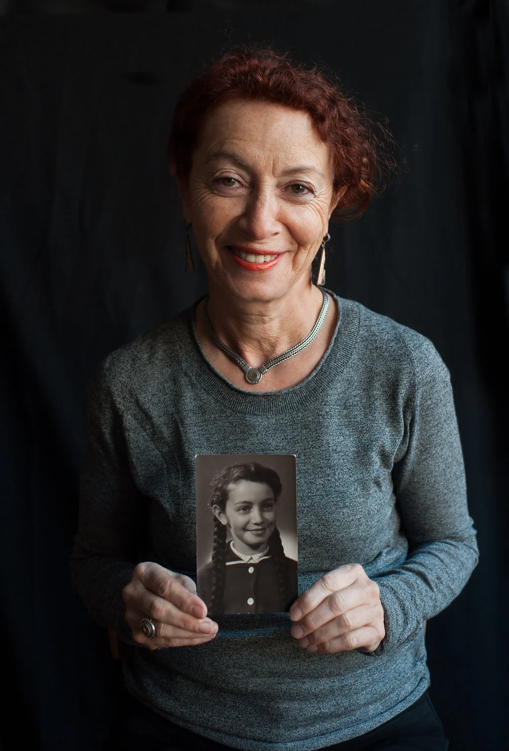 Elena, Phil's mother, holds a photo of herself as a child.
