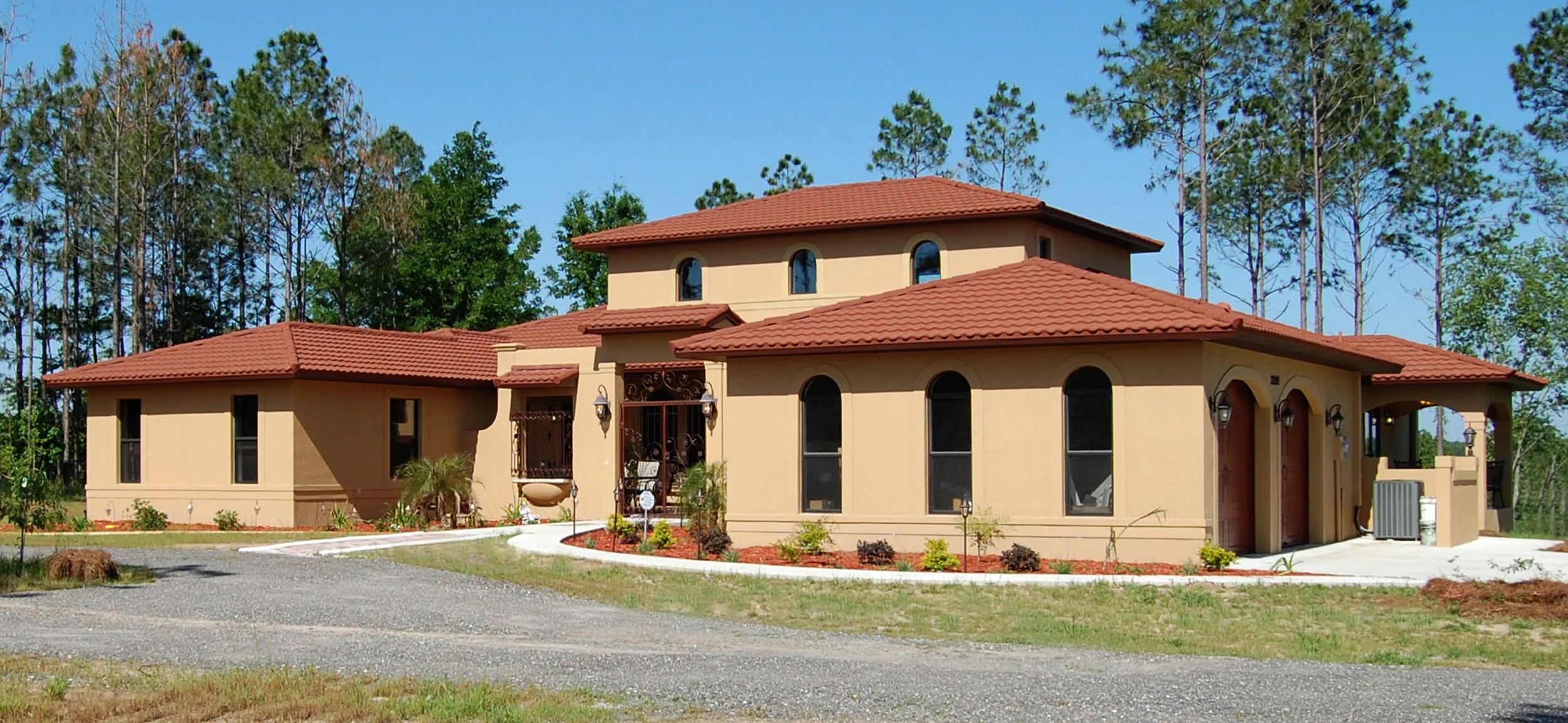  Front Elevation of Home as seen on approach. Home was landscaped with fruit bearing plants and trees. Photo 2010. 